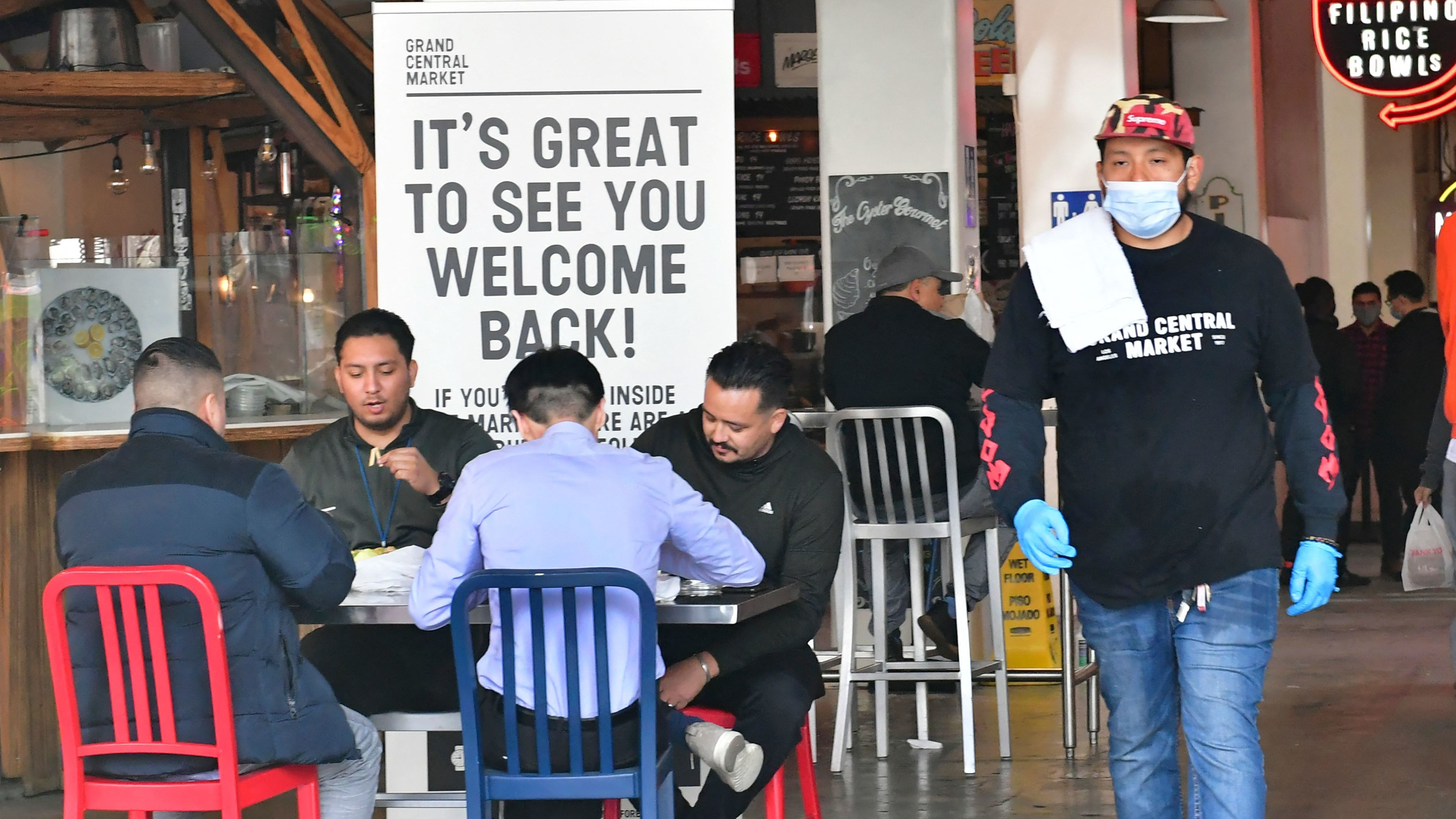 People enjoy lunch at Grand Central Market as indoor dining reopens in Los Angeles on March 15. The U.S. economy expanded at a rapid pace in the first three months of the year and is expected to grow at its fastest rate since 1984. (AFP via Getty Images)