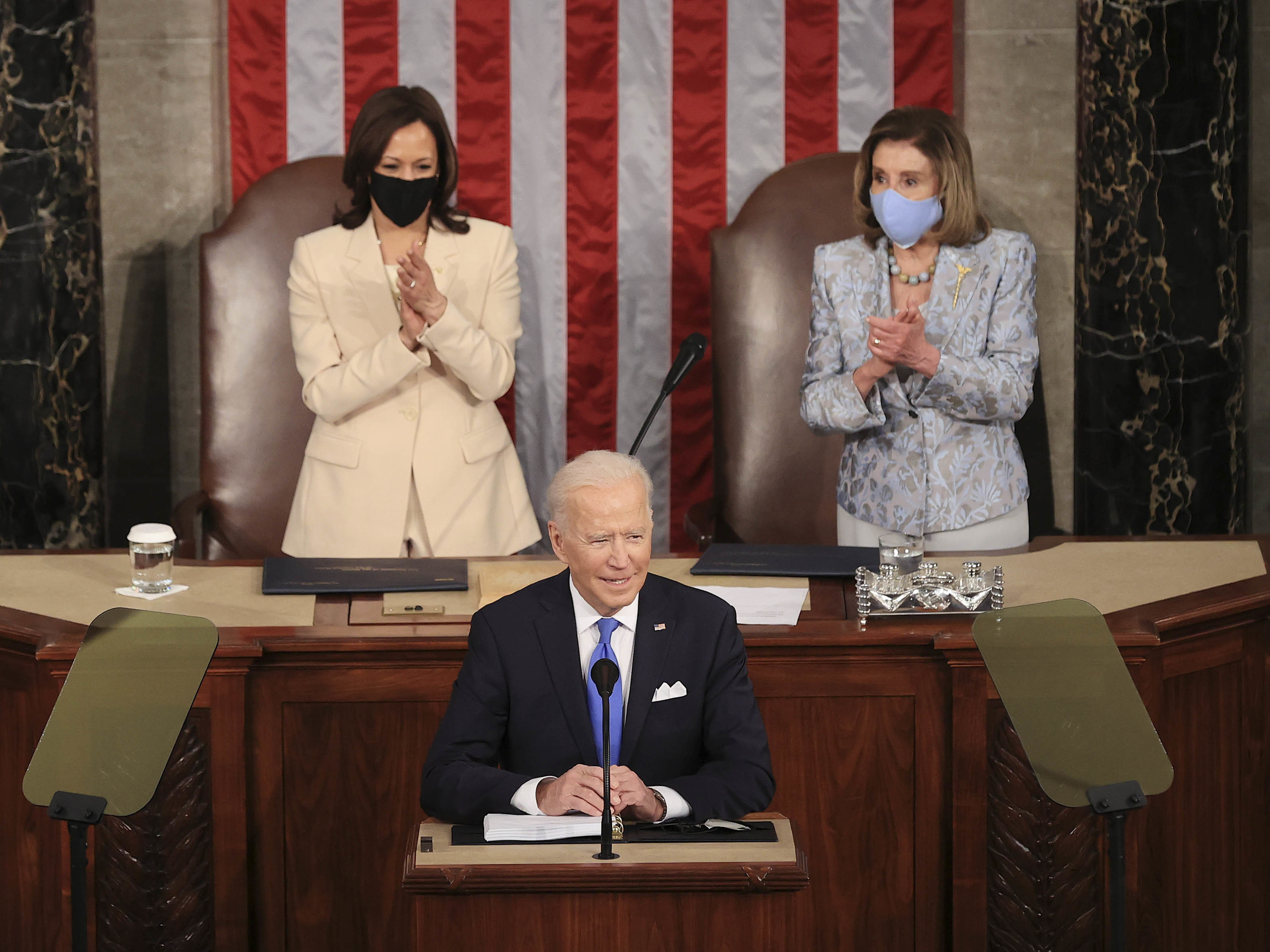 In a historic first, President Biden was flanked by two women — House Speaker Nancy Pelosi and Vice President Harris — as he addressed a joint session of Congress at the U.S. Capitol on Wednesday. (Bloomberg via Getty Images)