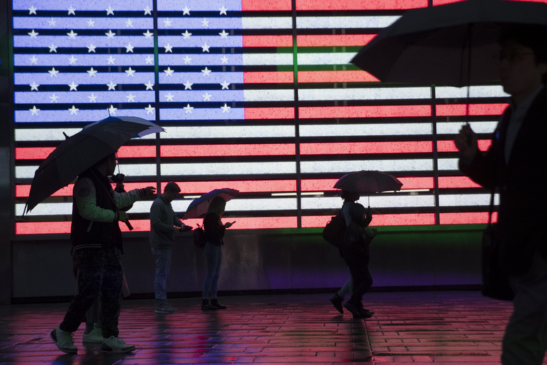 People holding umbrellas walk through New York City's Times Square in 2019. The U.S. Census Bureau plans to change how it protects the confidentiality of people's information in the detailed demographic data it produces through the 2020 count. (Mary Altaffer/AP)