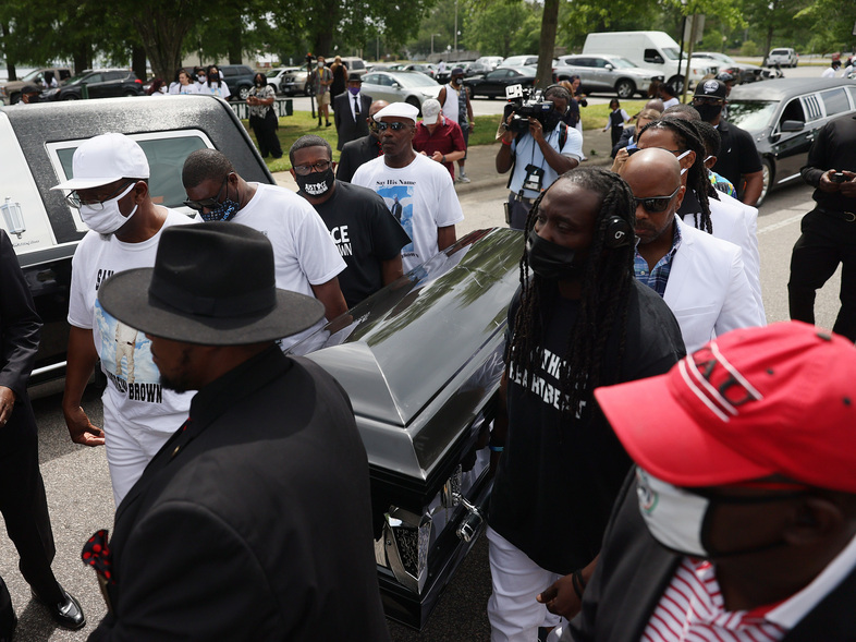 Pallbearers carry Brown's casket to a horse-drawn carriage before his funeral service Monday at the Fountain of Life Church in Elizabeth City, N.C. (Joe Raedle/Getty Images)