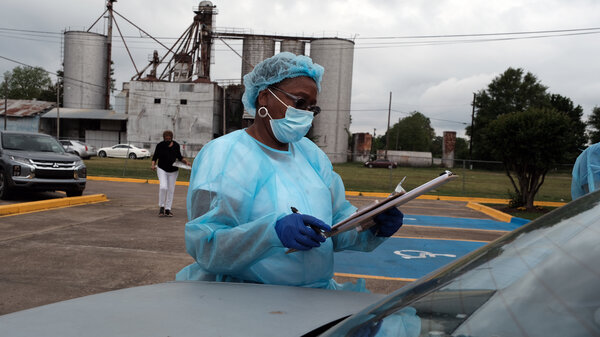 Medical workers with Delta Health Center prepare to vaccinate people in Leland, Miss., last week. In some places, rural hospital workers have been slow to get the vaccine themselves.