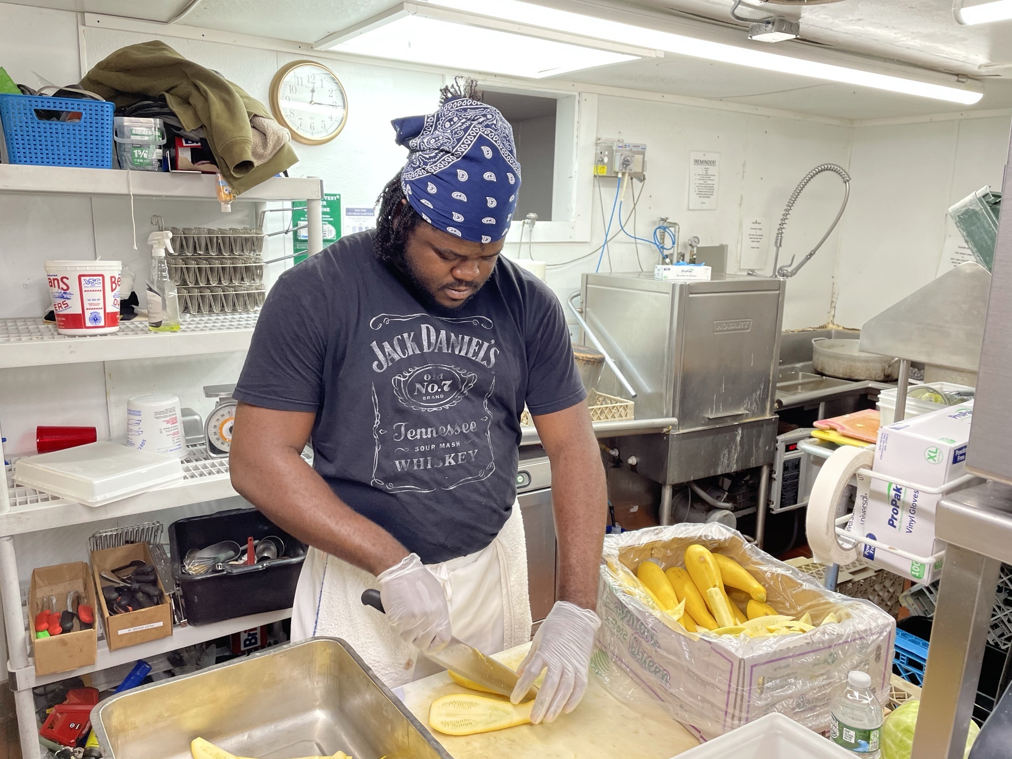 Jason Brissett, a kitchen worker who came to the U.S. last month from Jamaica through an H-2B visa, is bracing for 80-hour workweeks this summer to make up for staffing shortages. (NPR)