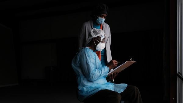 Medical workers wait to vaccinate people at a pop-up COVID-19 vaccination clinic last month in Hollandale, Miss.