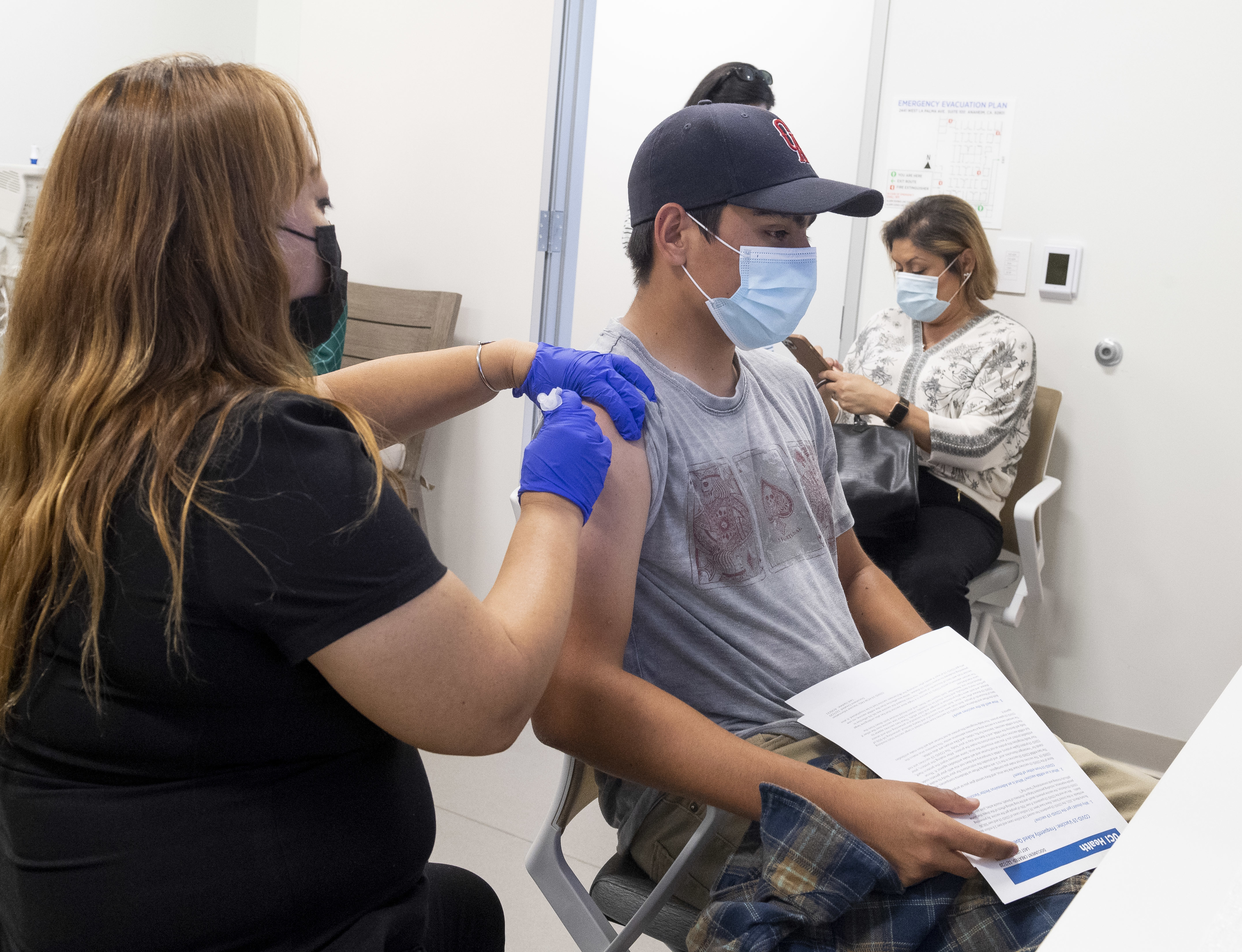 This 16-year-old got a Pfizer-BioNTech COVID-19 shot late last month at the UCI Health Family Health Center in Anaheim, Calif. Students as young as 12 are now eligible to get the vaccine, too, the FDA says. (Paul Bersebach/MediaNews Group/Orange County Register via Getty Images)