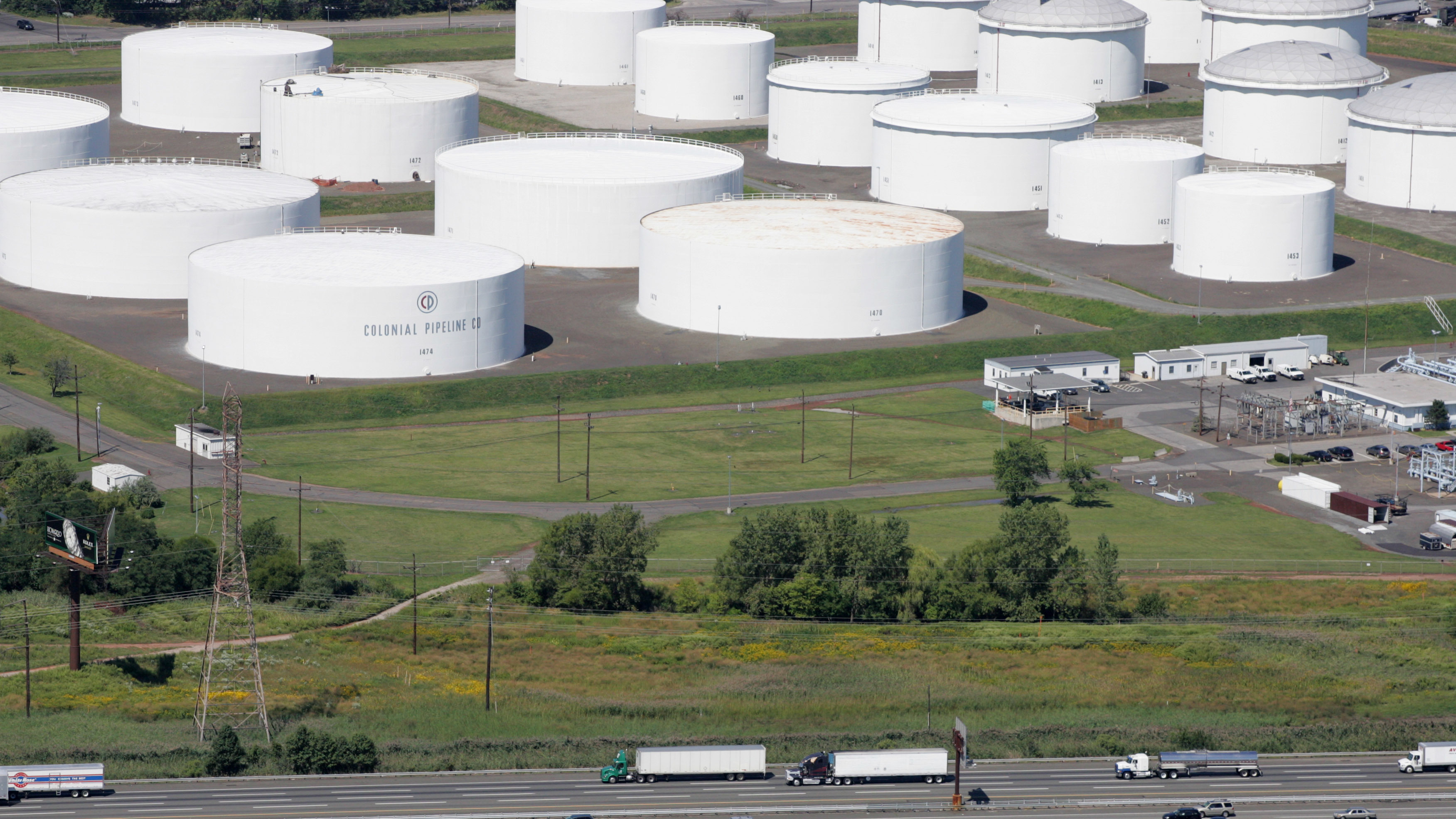 Traffic on I-95 passes oil storage tanks owned by the Colonial Pipeline Co. in Linden, N.J. An cybersecurity attack has shut down Colonial Pipeline, a major transporter of gasoline along the East Coast.