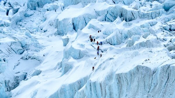 China will set up a "line of separation" at Mount Everest's summit, as Nepal struggles to control a COVID-19 outbreak. In this photograph, on May 2, 2021 mountaineers trek along the Khumbu glacier near Everest base camp in the Mount Everest region of Solukhumbu district, some 140 km northeast of Nepal's capital Kathmandu.