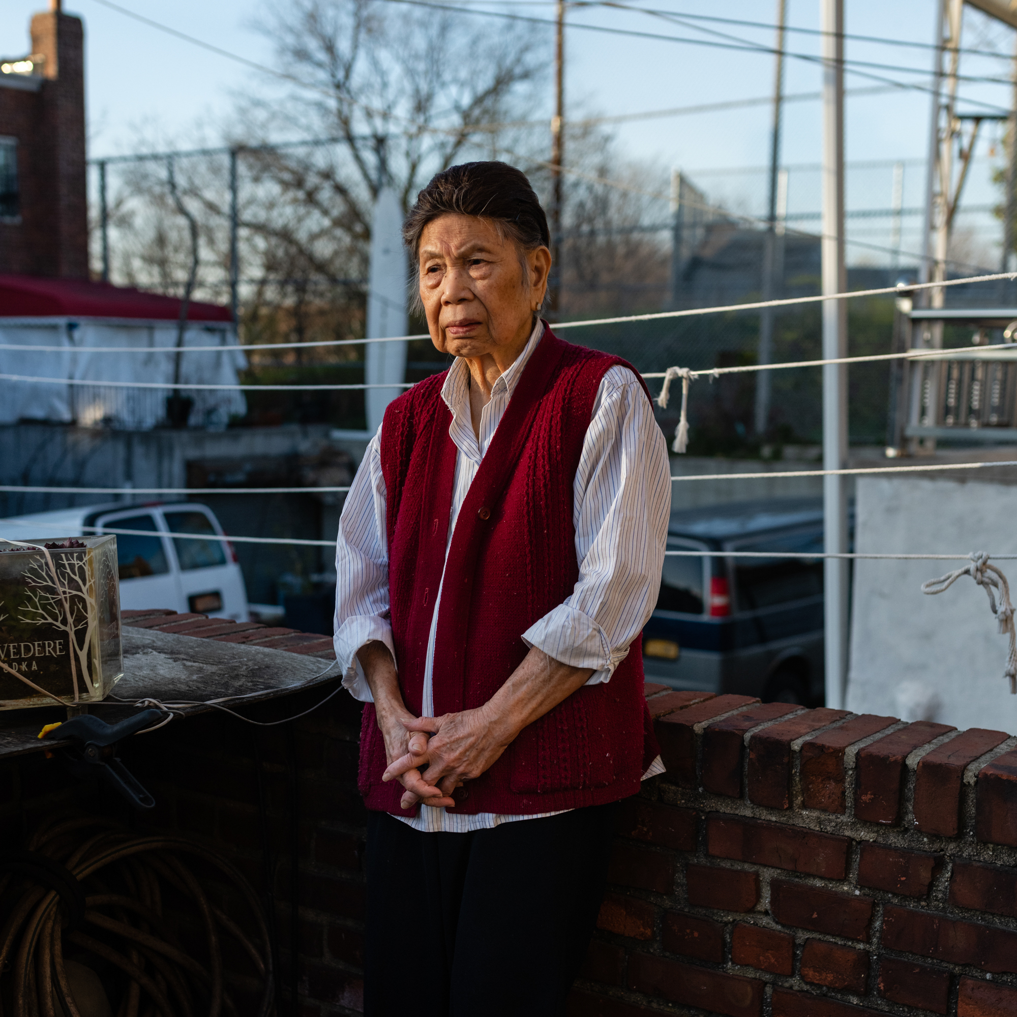 Juen Lee, 88, poses for a portrait on a patio in her home in Queens, New York (Eric Lee)