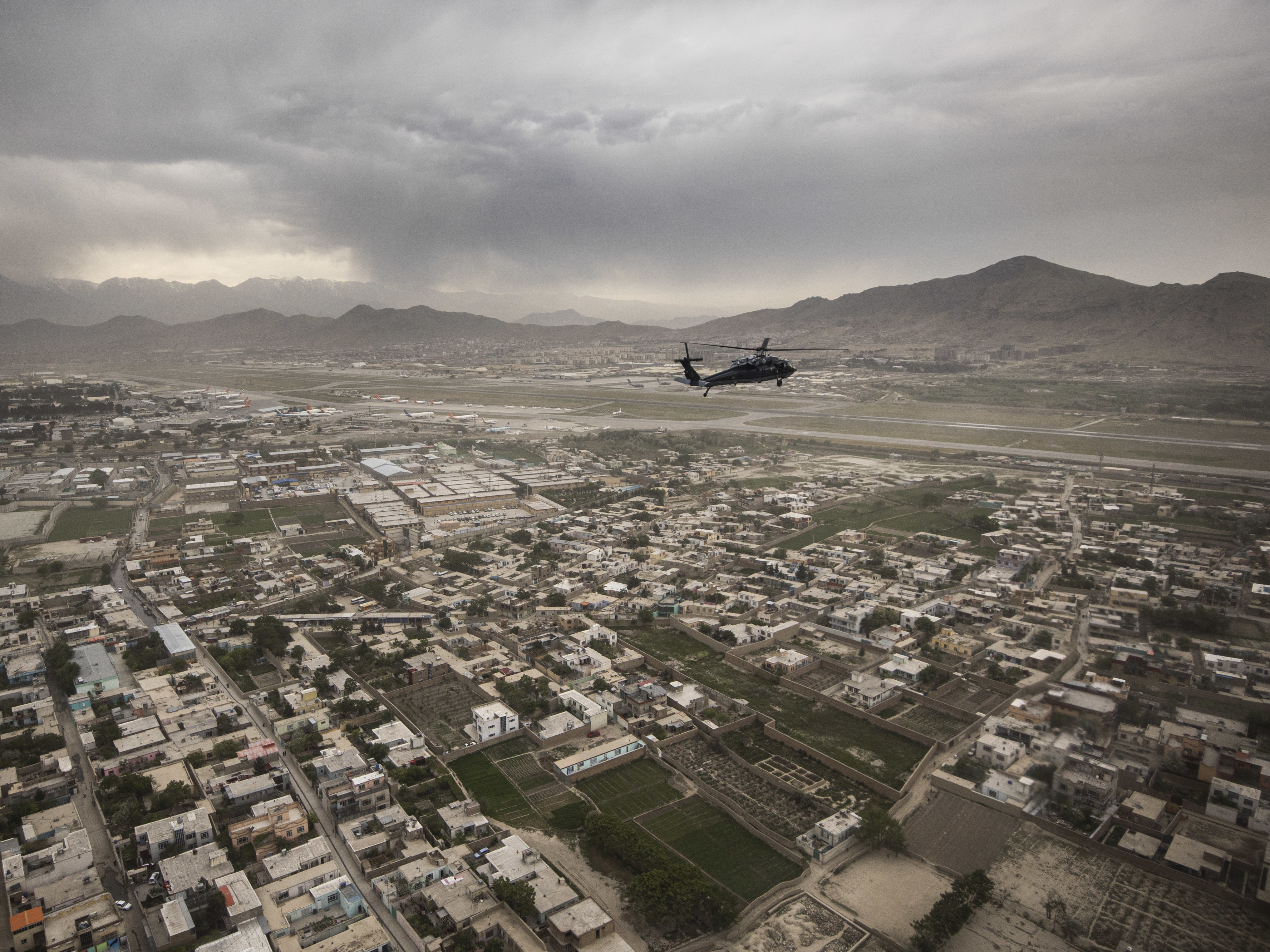 A Black Hawk helicopter of the U.S. Air Force flies over Kabul in April. (Photothek via Getty Images)