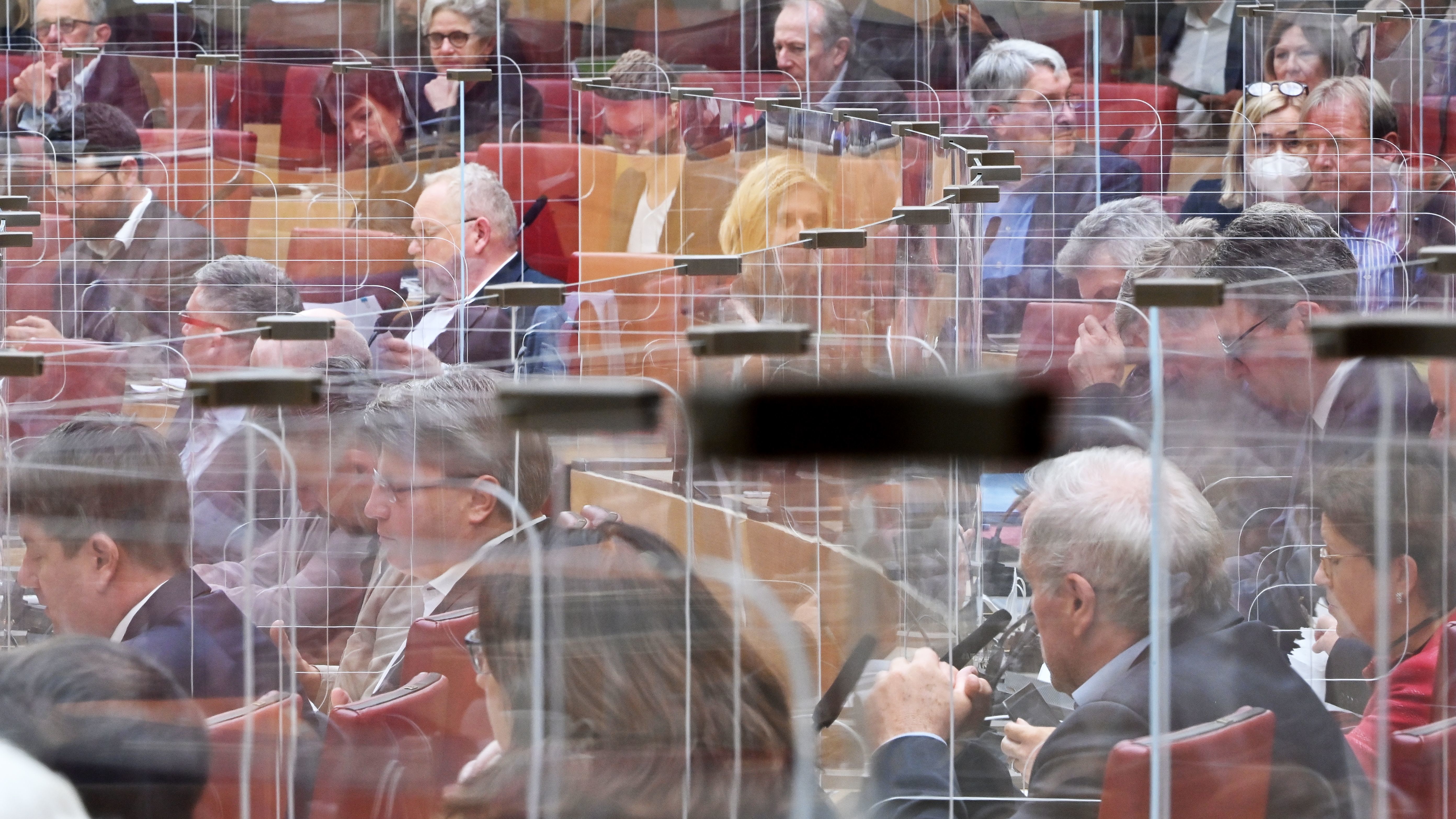 Calling COVID-19 &quot;a terrible wake-up call,&quot; an independent review panel says national and international leaders failed to respond adequately to the pandemic. Here, members of the Bavarian state Parliament sit among clear panels in Munich in October. (POOL/AFP via Getty Images)
