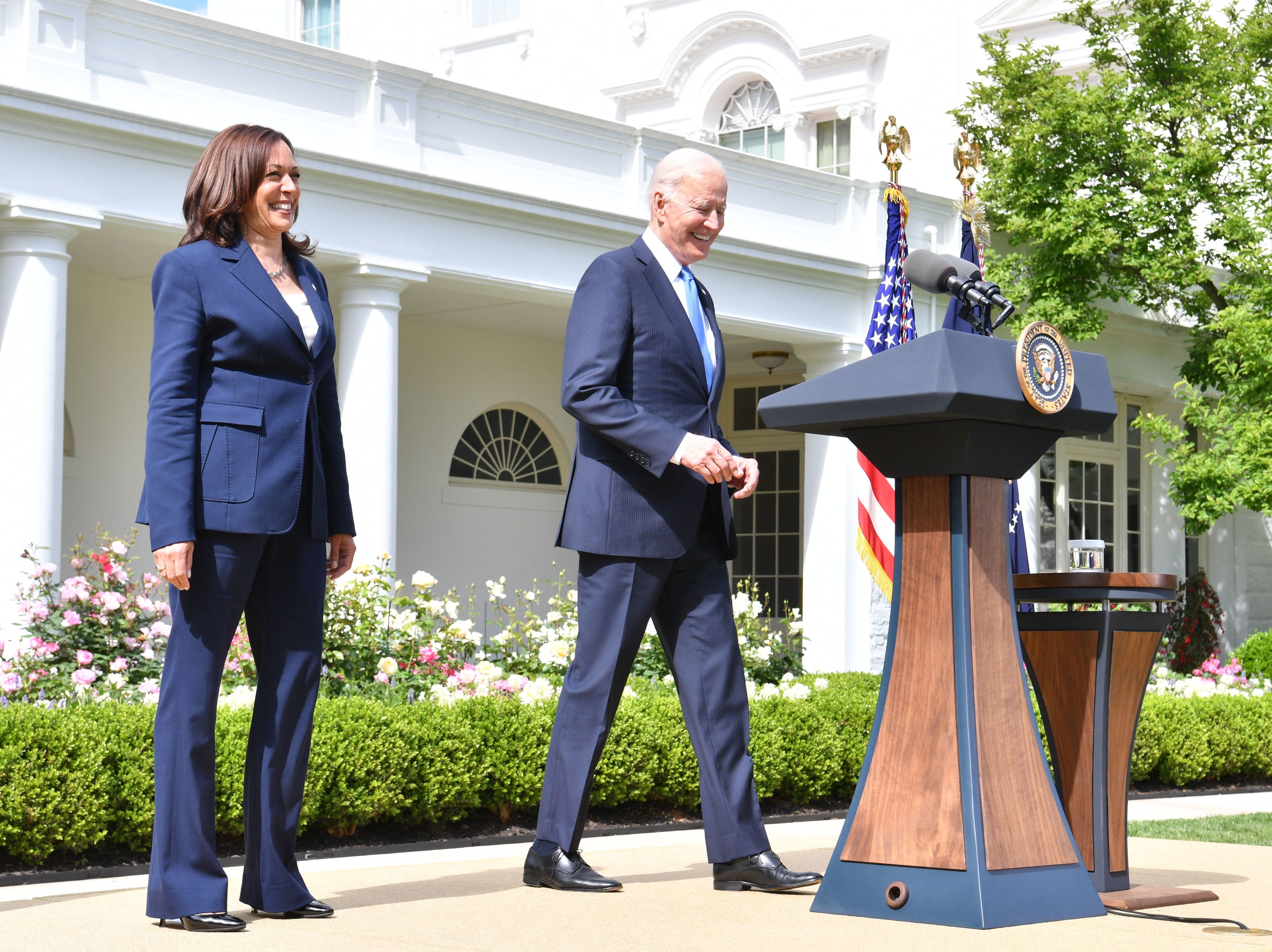President Biden arrives with Vice President Harris to discuss the CDC's new mask guidance in the Rose Garden of the White House on Thursday. (AFP via Getty Images)