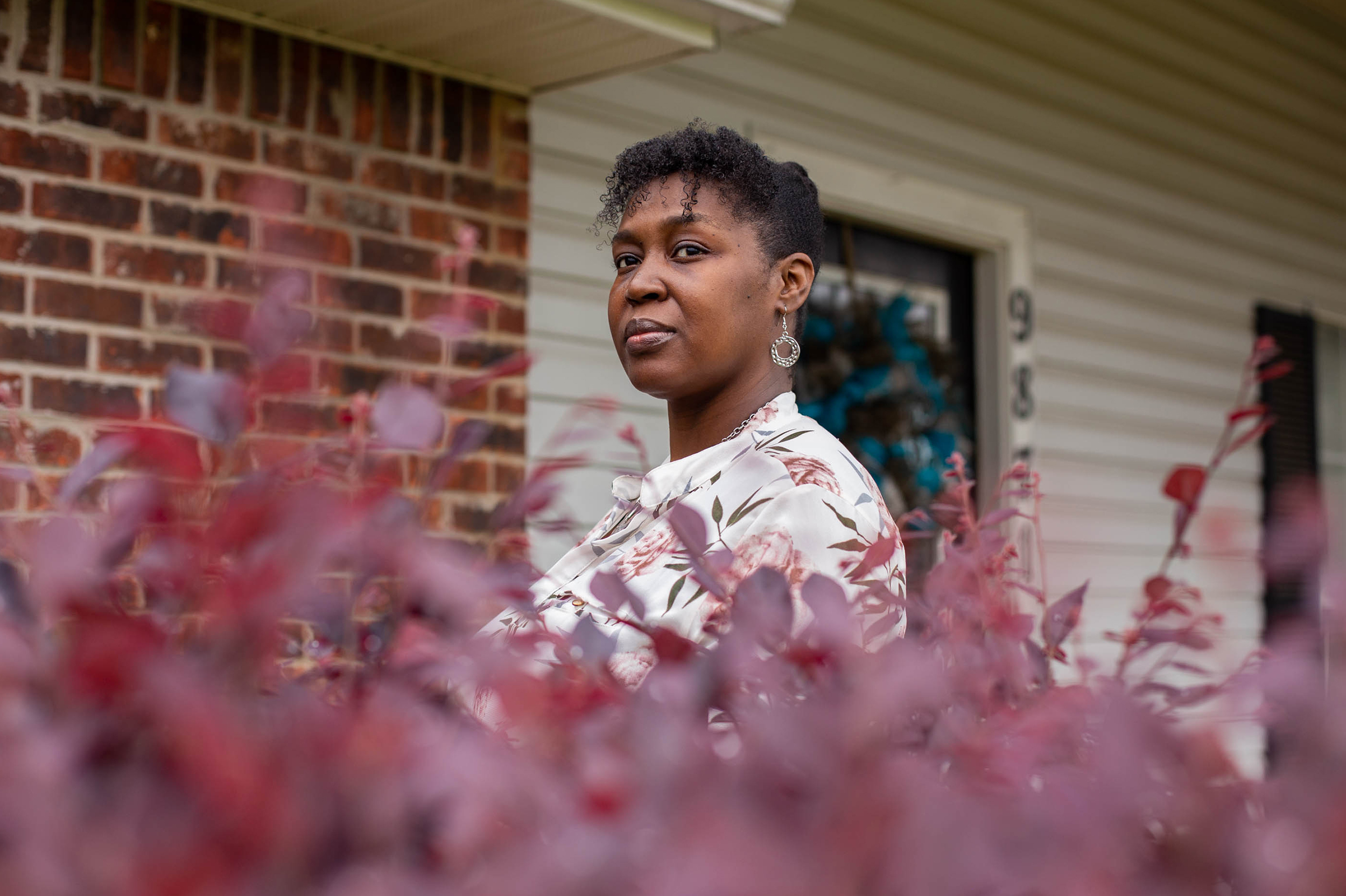 Tia Cunningham stands in front of her home in Byram, Miss., on Wednesday. She's a past recipient of a guaranteed income pilot project in Jackson, and it helped her save up for a down payment. (Imani Khayyam for NPR)