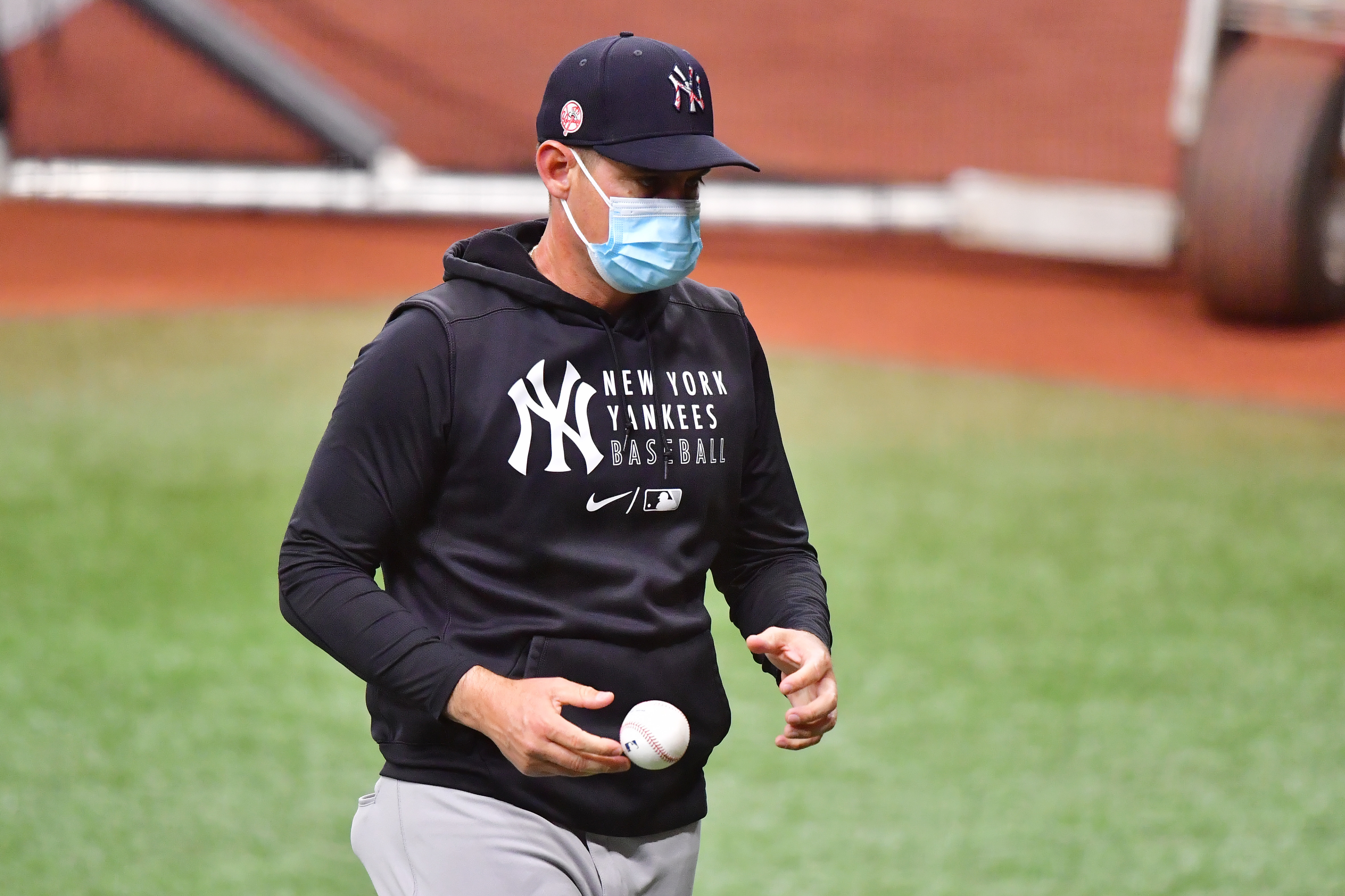 The New York Yankees, including manager Aaron Boone, are back to wearing masks after the team reported eight &quot;breakthrough&quot; COVID-19 cases this week. (Getty Images)