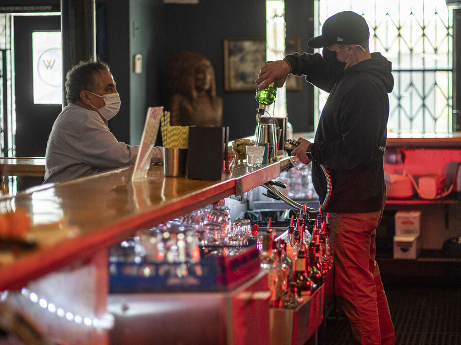 A bartender mixes a drink inside a bar last week in San Francisco. The latest retail sales data out on Friday showed an increase in sales at restaurants and bars as more people venture out amid the continued reopening of the U.S. economy. (David Paul Morris/Bloomberg via Getty Images)