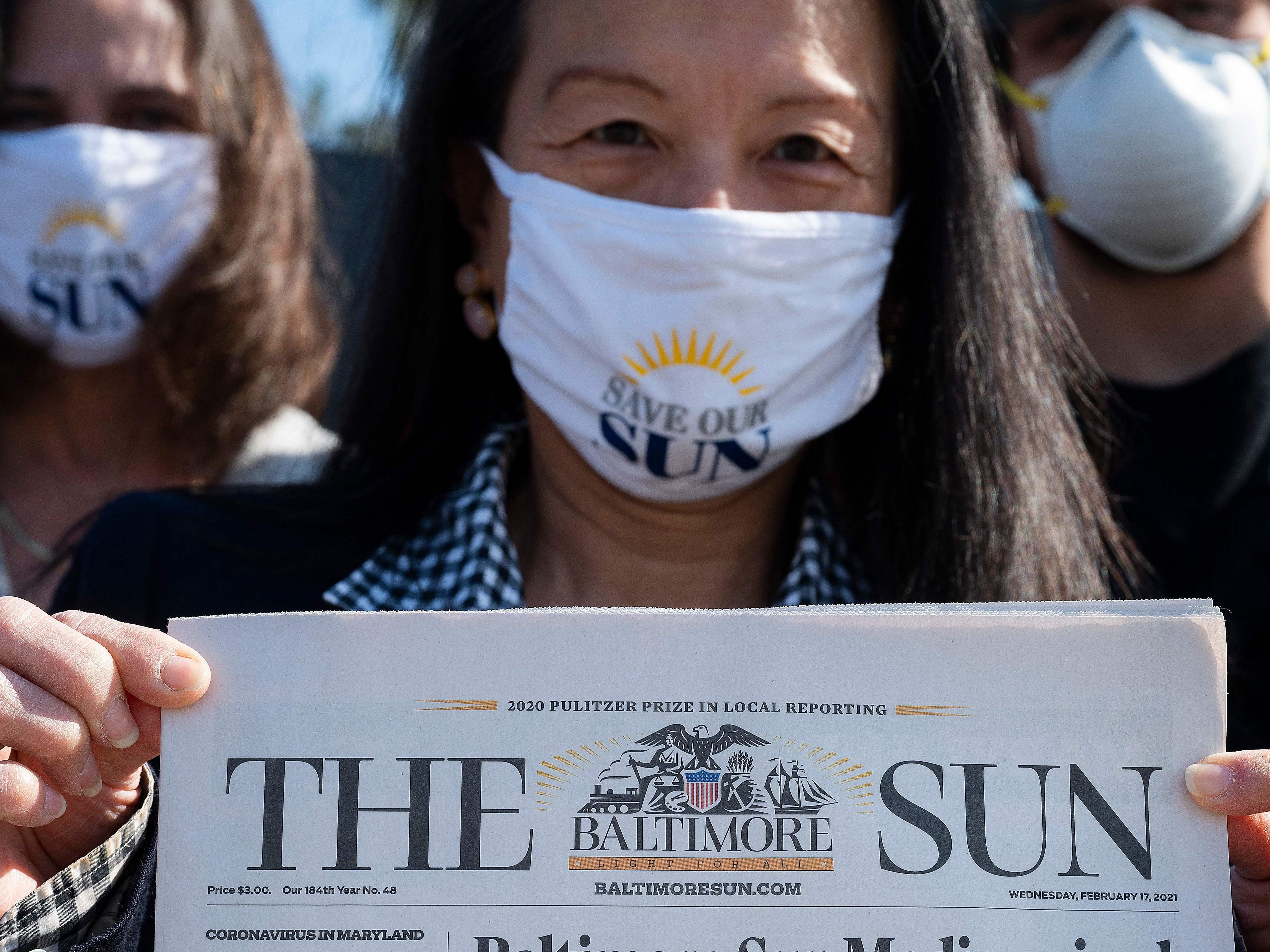 <em>Baltimore Sun</em> reporter Jean Marbella participates in a Save Our Sun rally in March, part of an effort to secure an alternative buyer to Alden Global Capital. (AFP via Getty Images)