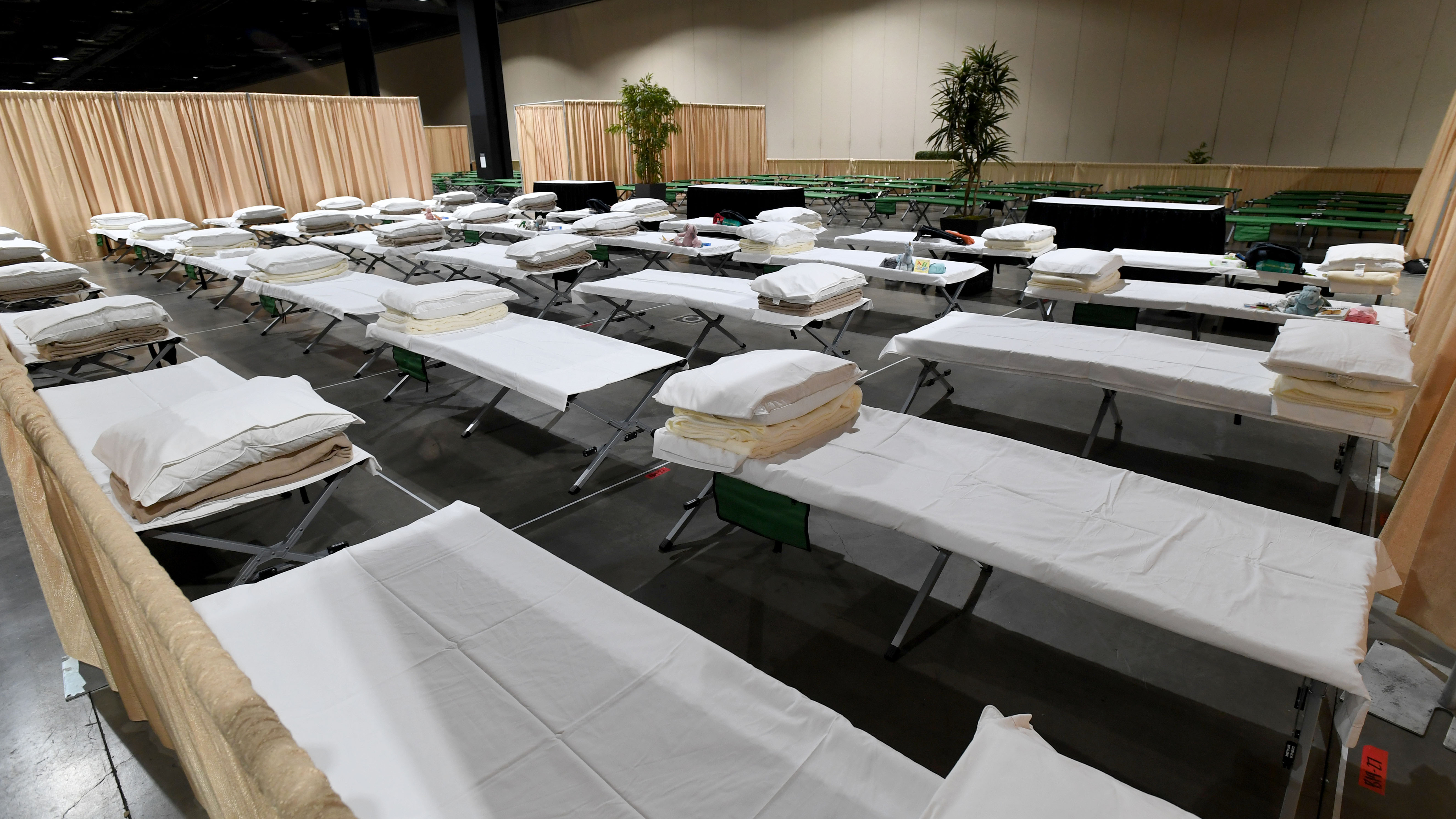 Sleeping quarters set up for migrant children are shown during a tour of the Long Beach Convention Center on April 22. Long Beach officials and officials with the U.S. Department of Health and Human Services led the tour. (Pool/Getty Images)