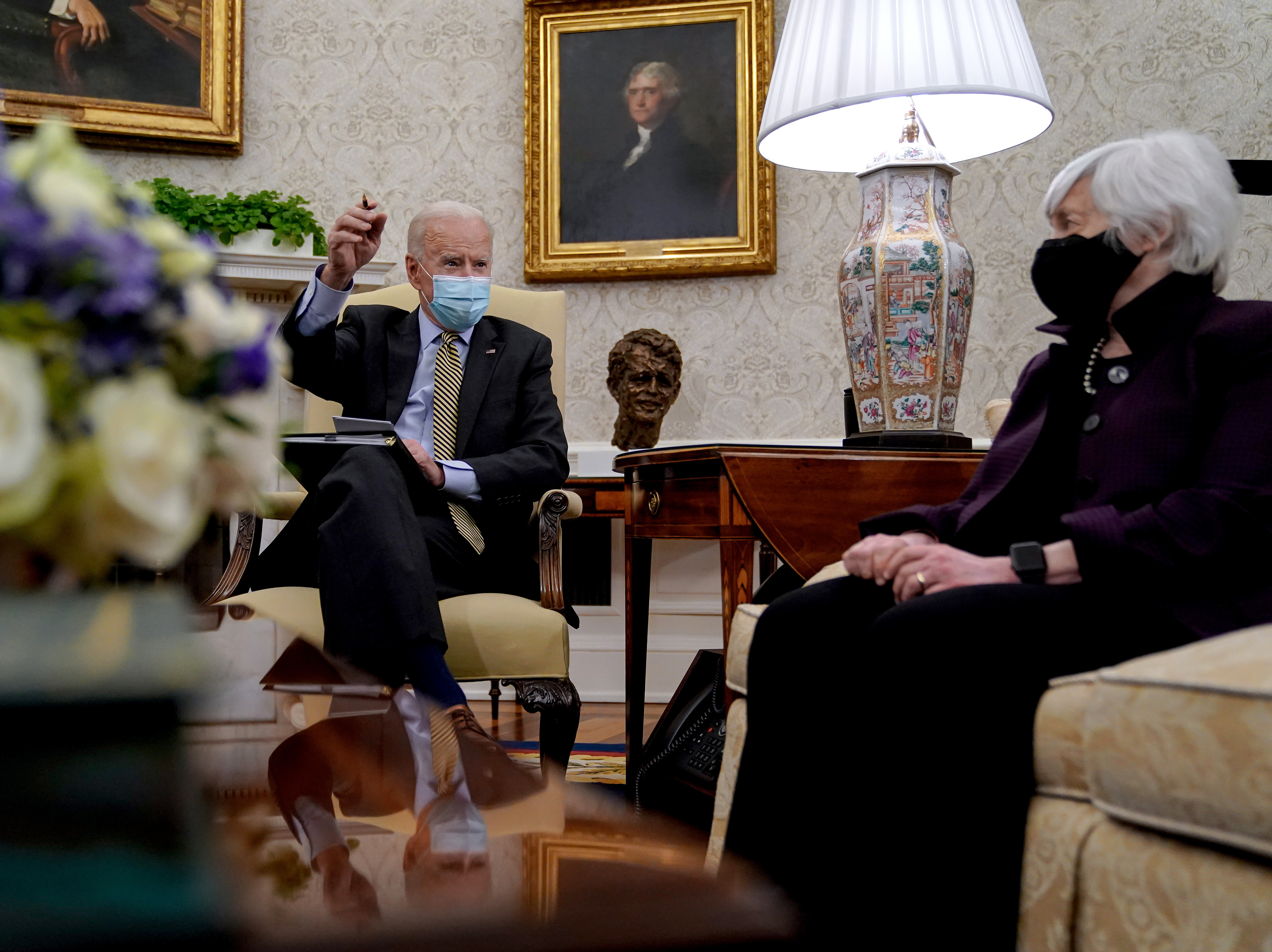 President Biden speaks as Treasury Secretary Janet Yellen listens during the weekly economic briefing in the Oval Office at the White House on April 9. Biden issued an executive order compelling Yellen and other regulators to assess the risk of climate change to America's financial system. (Getty Images)