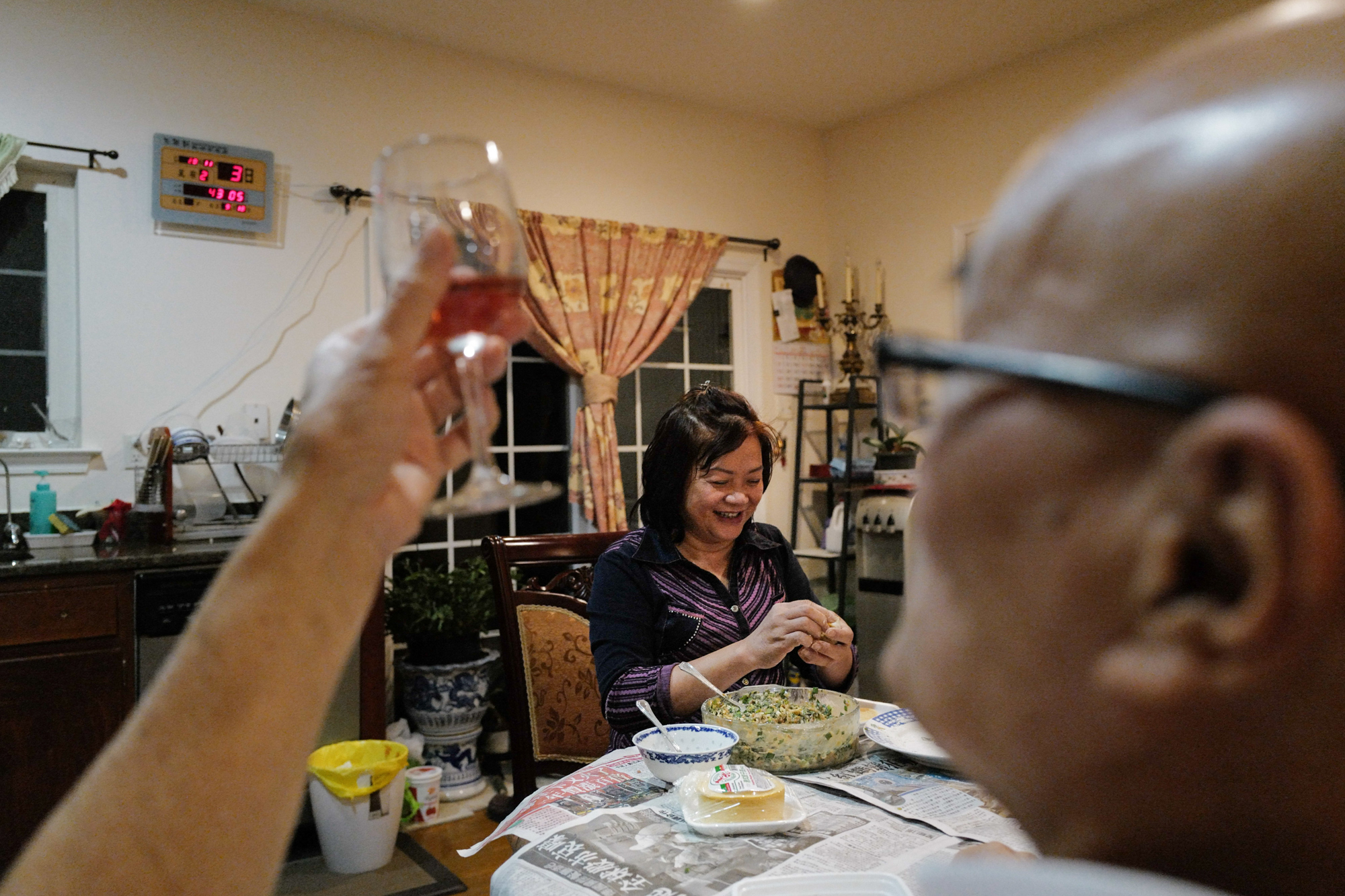 Photos: 2 Cantonese Women Share Their Immigrant Journey 10 After work, the couple make dumplings together. Here, Lai fills a dumpling with pork and shapes the remaining rounds, as Chan drinks wine and makes jokes.