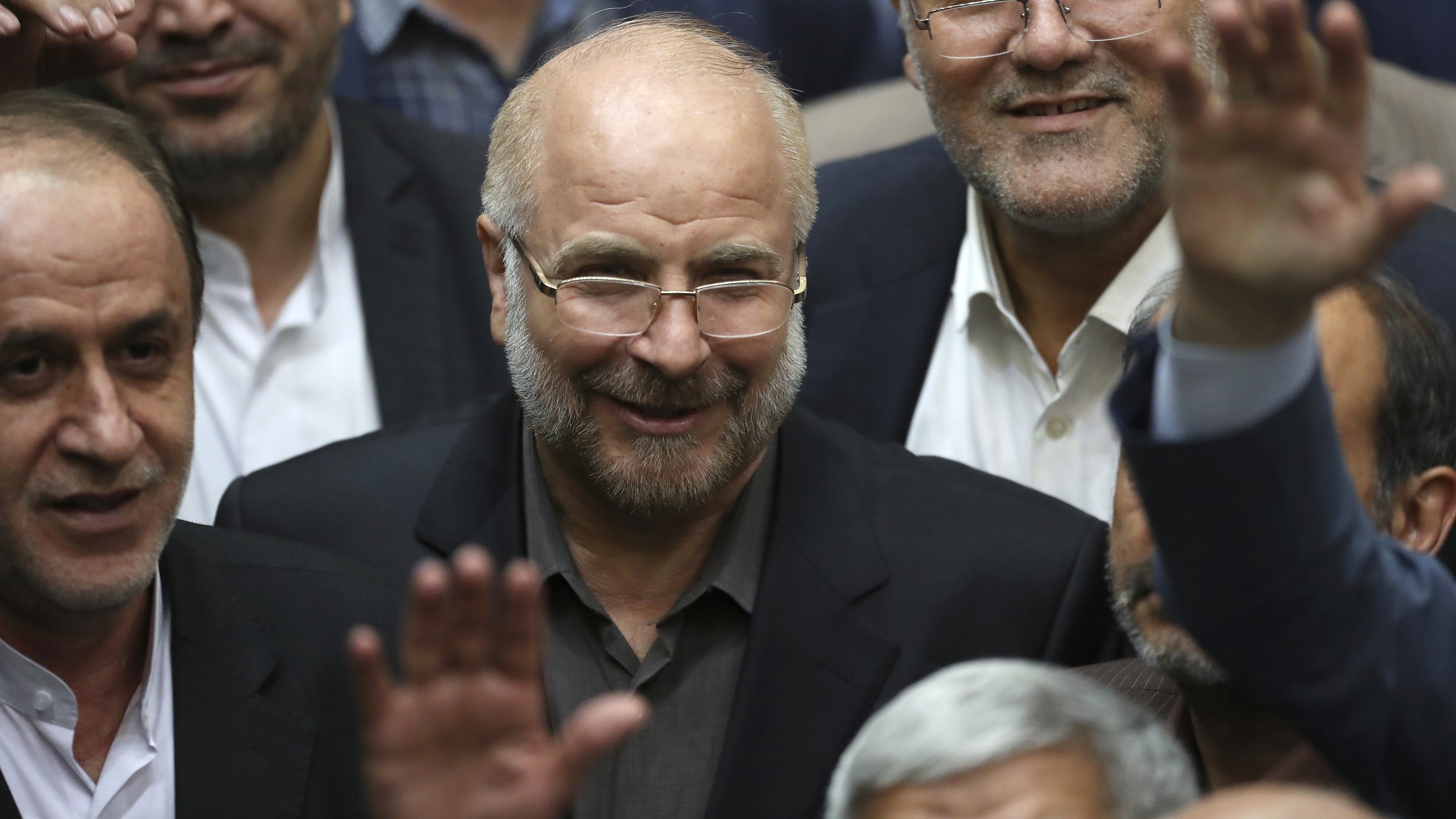 In this May 28, 2020, file photo, Mohammad Bagher Qalibaf, center, is surrounded by a group of lawmakers after being elected as speaker of the parliament, in Tehran, Iran. Iran