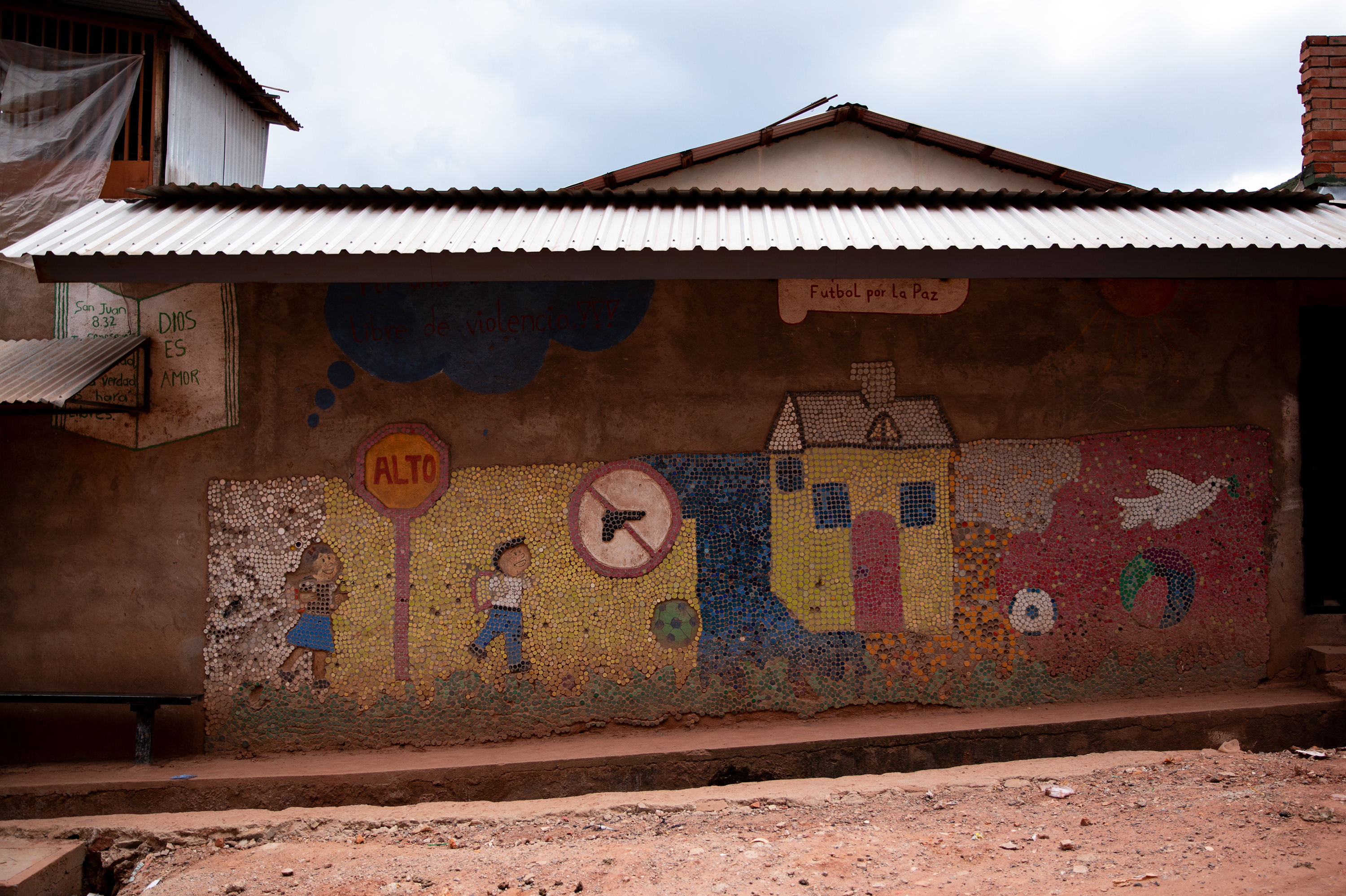 An anti-violence mural on the wall of a street in Tegucigalpa, the capital city of Honduras. The Biden administration has pledged $4 billion to attack the root causes of out-migration from Central America. (Tomas Ayuso for NPR)