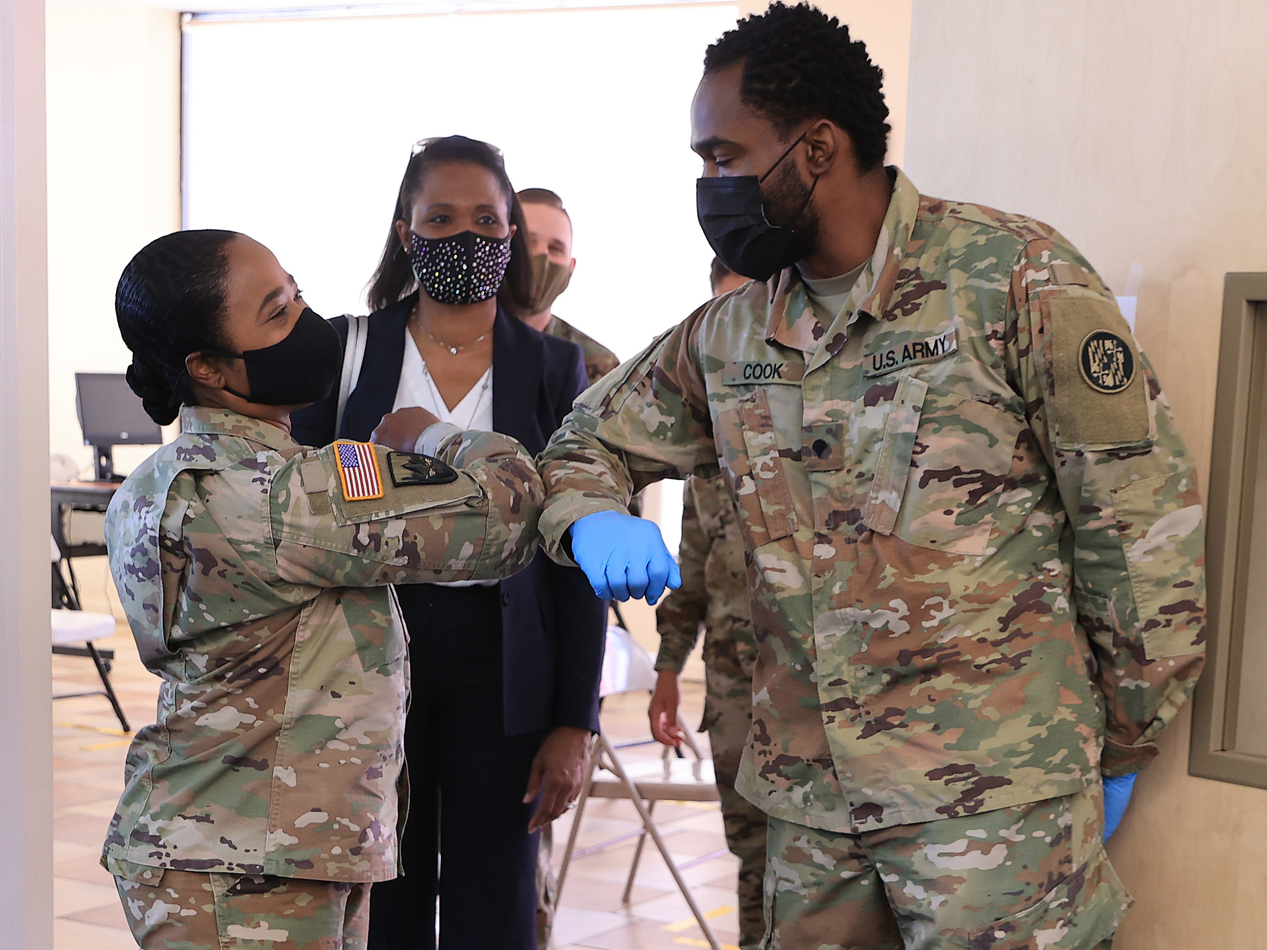 Nearly 130 million U.S. adults have completed their vaccine regimens, the CDC says, with another 70 million vaccine doses currently in the distribution pipeline. Here, Maryland National Guard Brig. Gen. Janeen Birckhead greets soldiers last week at a mobile vaccine clinic in Wheaton, Md. (Getty Images)