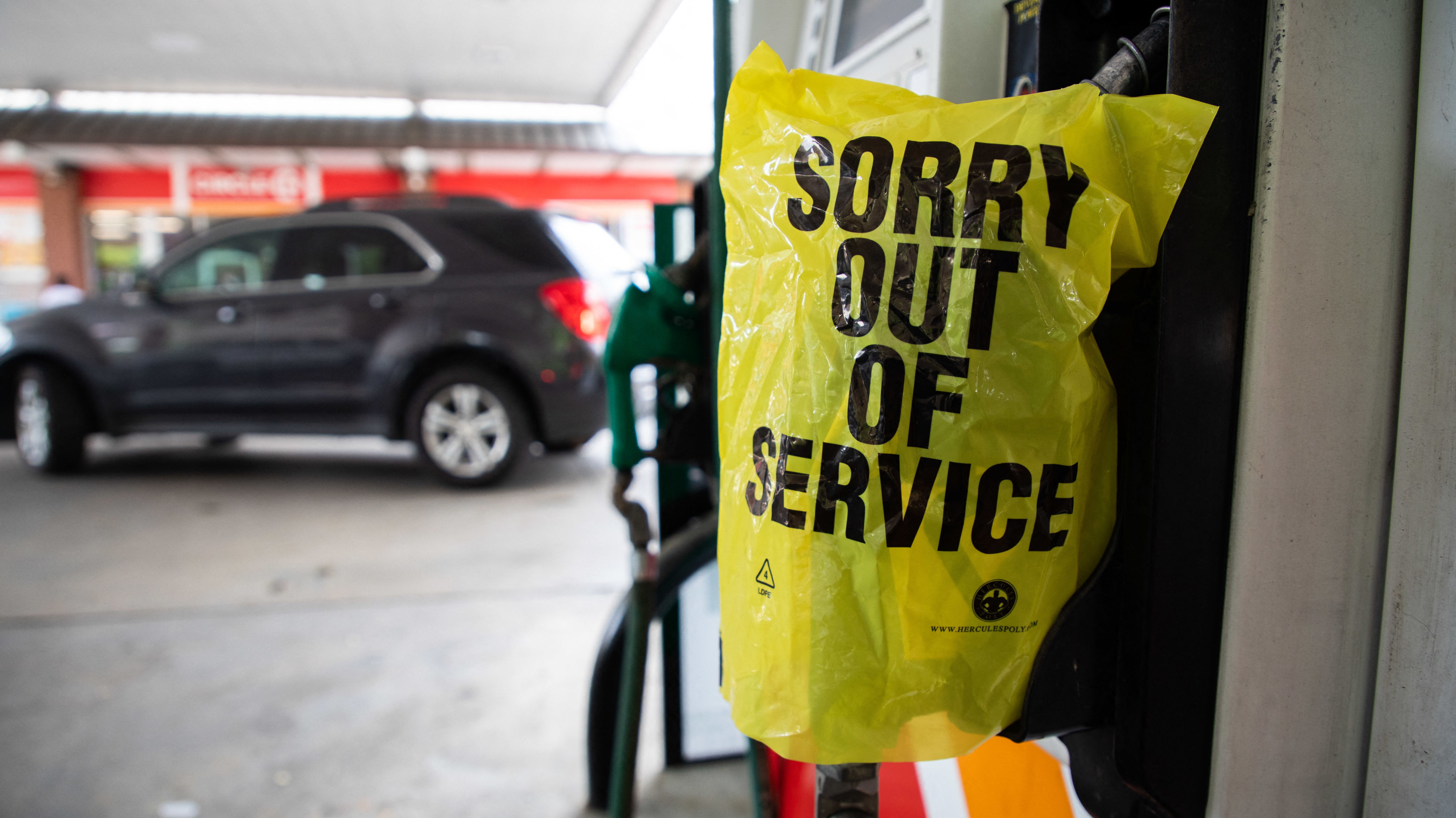 A gas pump is marked "out of service" as cars line up May 11 at a Circle K in Charlotte, N.C., following a ransomware attack that shut down Colonial Pipeline.