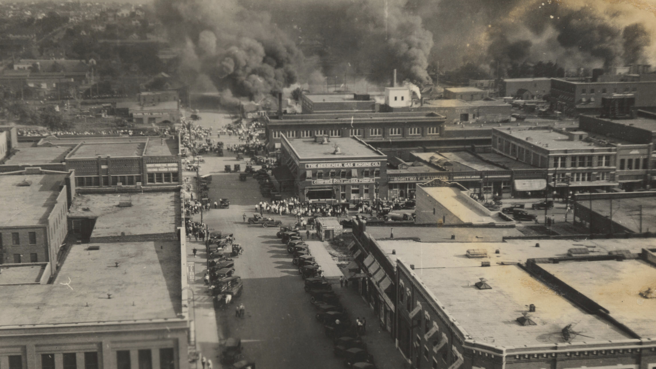 This archival photo shows crowds of people watching fires during the June 1, 1921, Tulsa Race Massacre. (Department of Special Collections, McFarlin Library, The University of Tulsa via AP)