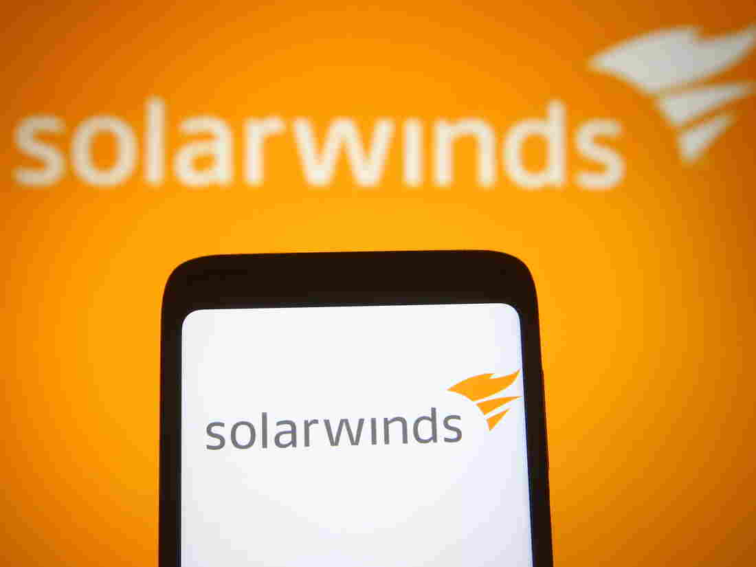 UKRAINE - 2021/03/30: In this photo illustration the SolarWinds logo of an US company that develops software is seen on a smartphone and a pc screen. (Photo Illustration by Pavlo Gonchar/SOPA Images/LightRocket via Getty Images)