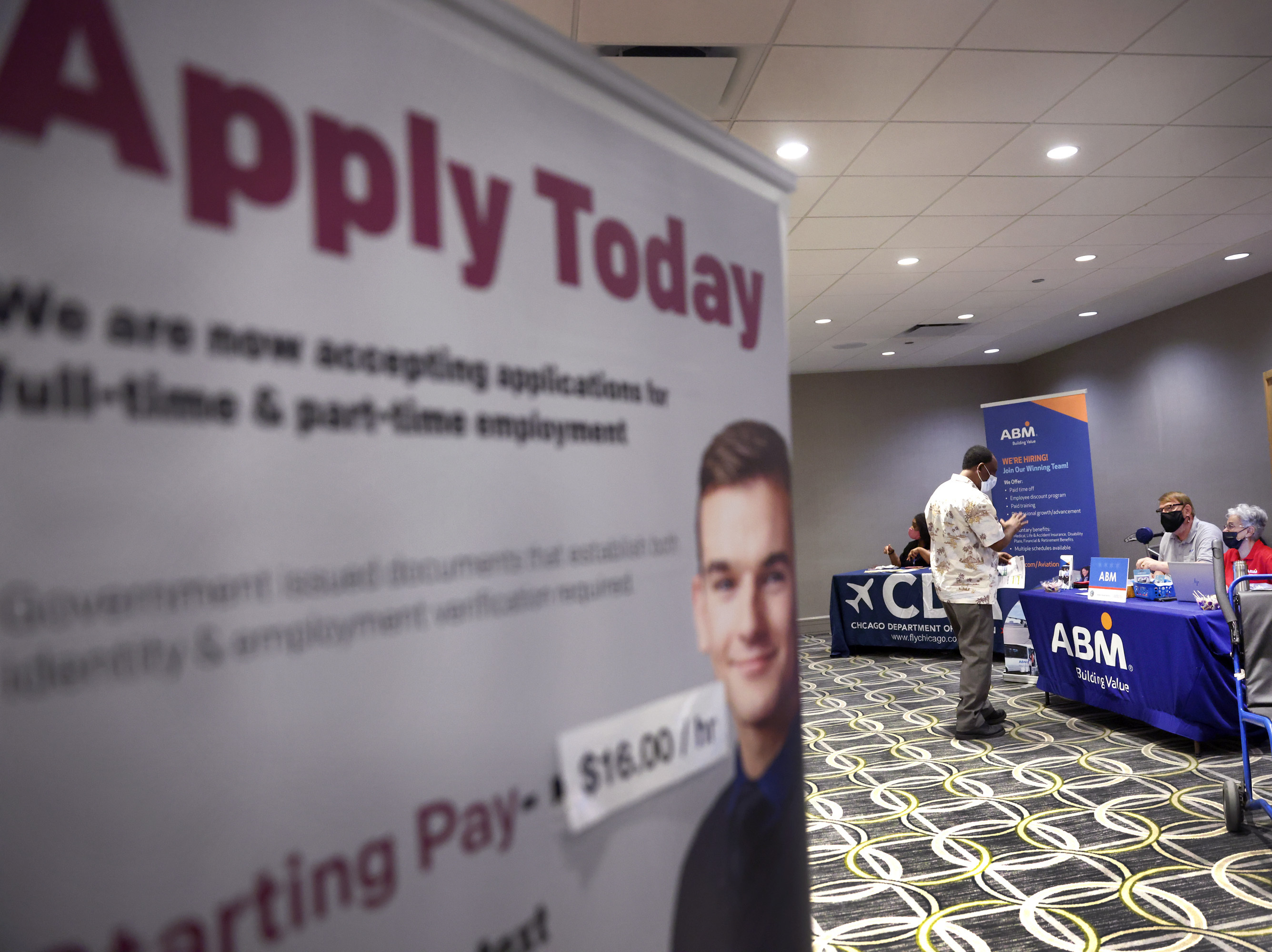 Recruiters looking to fill positions at O'Hare International Airport meet with candidates during a job fair at the Chicago airport on May 19. Hiring was expected to have picked up last month, providing a shot of relief to an economy in need of workers as businesses start to reopen again. (Getty Images)