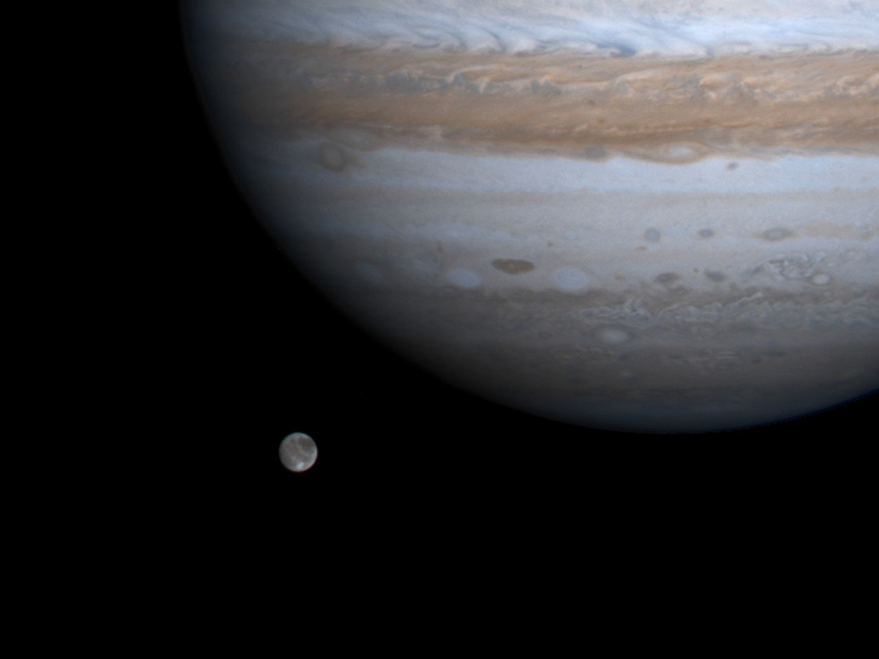 The solar system's largest moon, Ganymede, is pictured with Jupiter in a photo by NASA's Cassini spacecraft on Dec. 3, 2000. NASA's Juno mission got close to Ganymede on Monday. (Getty Images)