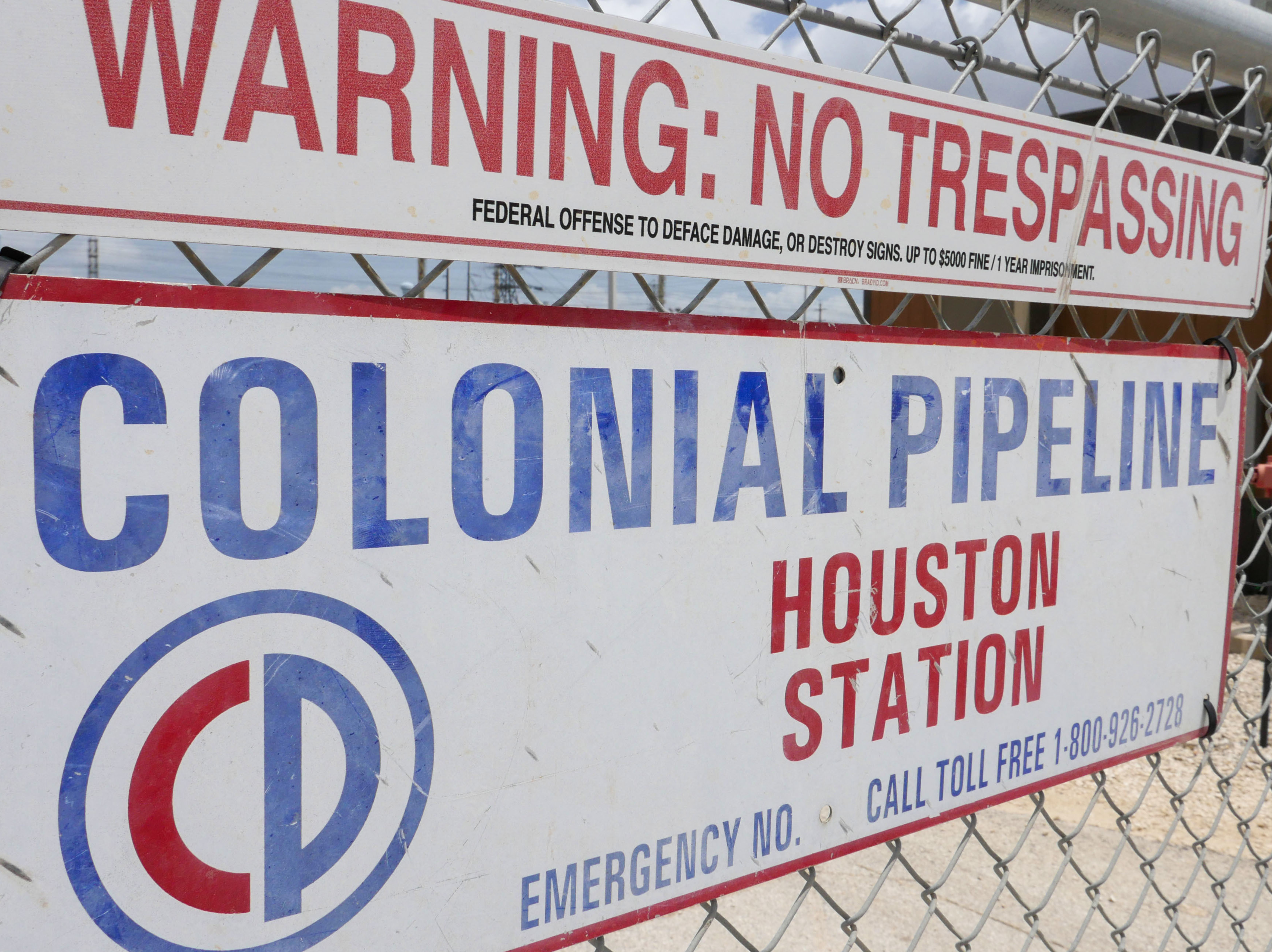 A sign at the Colonial Pipeline Houston Station facility in Pasadena, Texas, warns against trespassing. Colonial was forced to shut down a key pipeline last month after suffering a ransomware attack. Such attacks are becoming more frequent and increasingly, they are targeting key infrastructure like fuel or food supplies. (AFP via Getty Images)