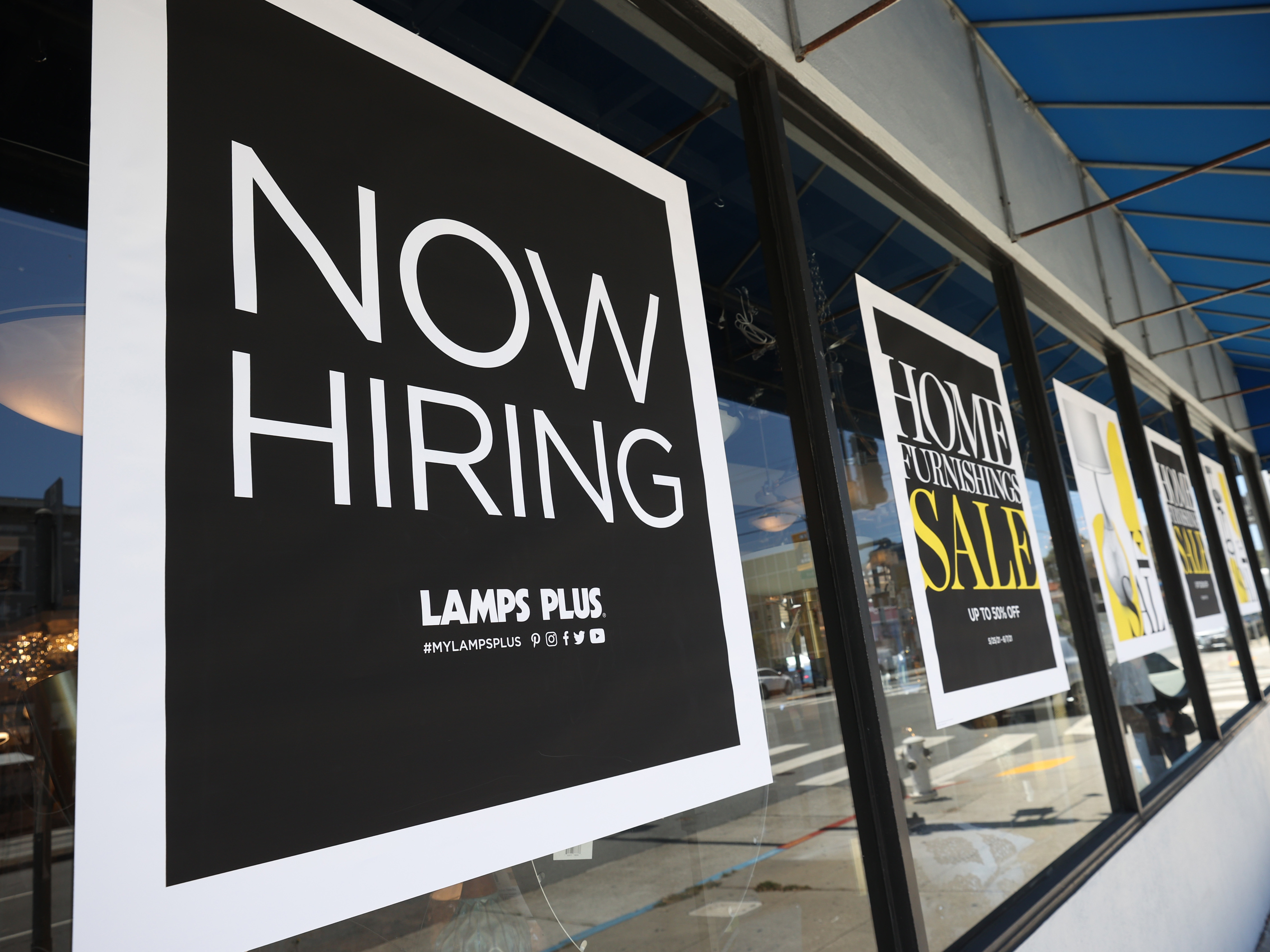 A pedestrian walks by a &quot;Now Hiring&quot; sign outside of a Lamps Plus store in San Francisco on on June 3. Four states, including Mississippi, are moving to end an extra $300-a-week unemployment benefit, arguing the pay is discouraging people from finding work. (Getty Images)