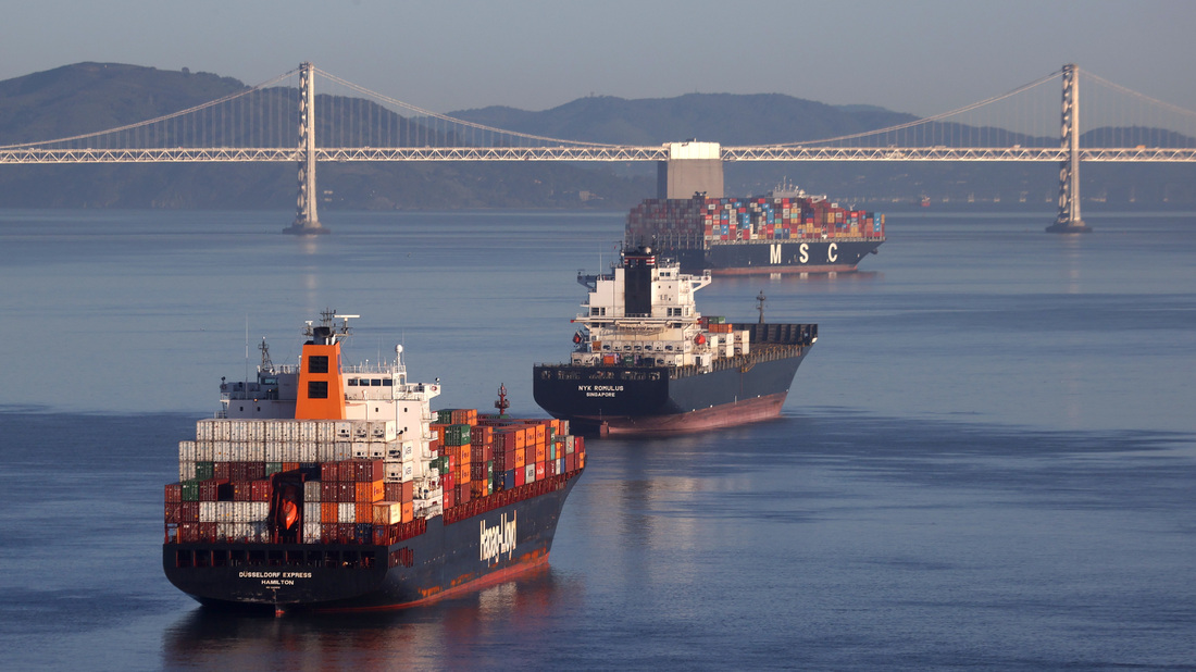 Container ships sit idle in San Francisco Bay just outside of the Port of Oakland in San Francisco in March.