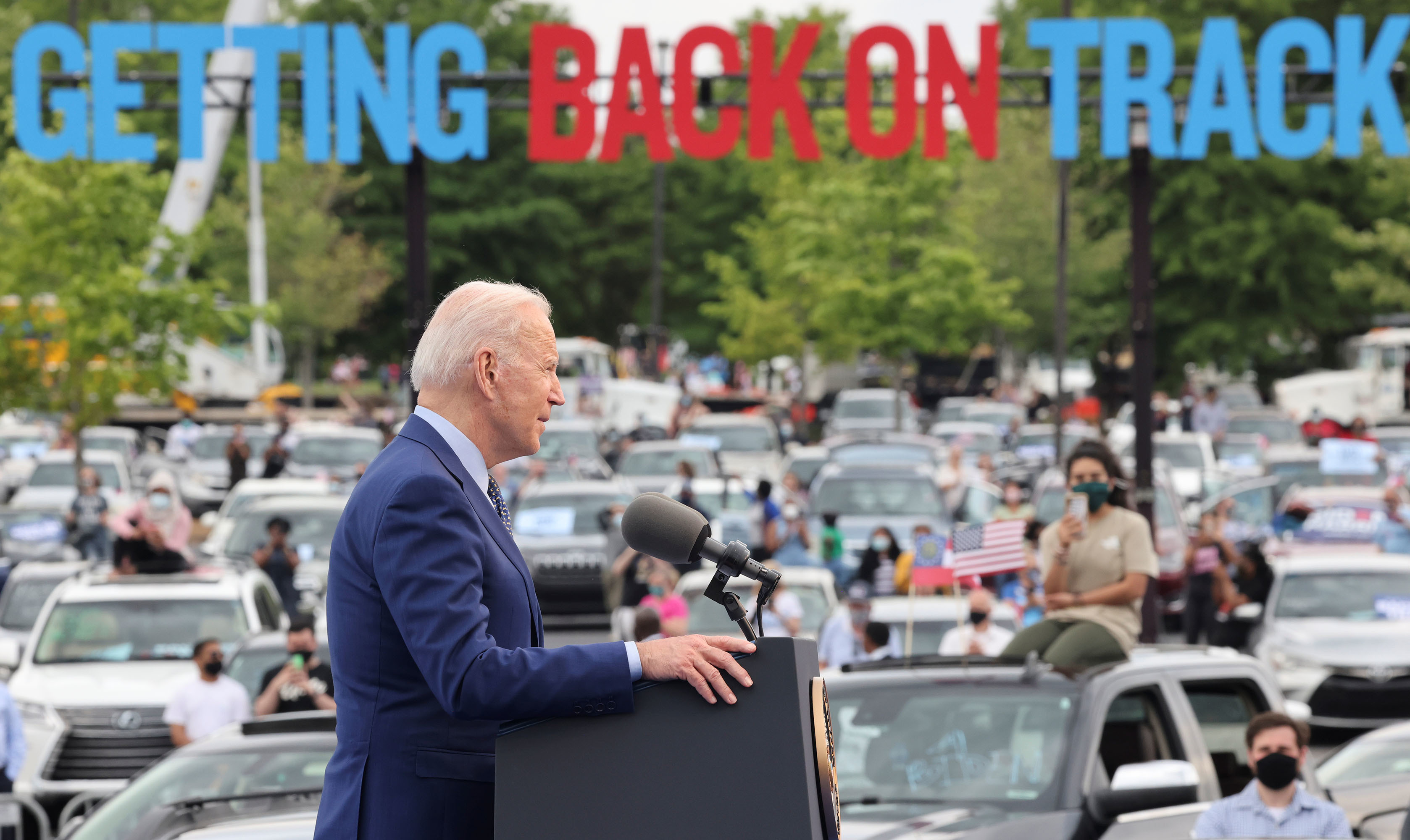 President Joe Biden speaks during the Democratic National Committee's &quot;Back on Track&quot; drive-in car rally in Duluth, Georgia, to celebrate his 100th day in office. Immigrant advocates were there to protest. (REUTERS)
