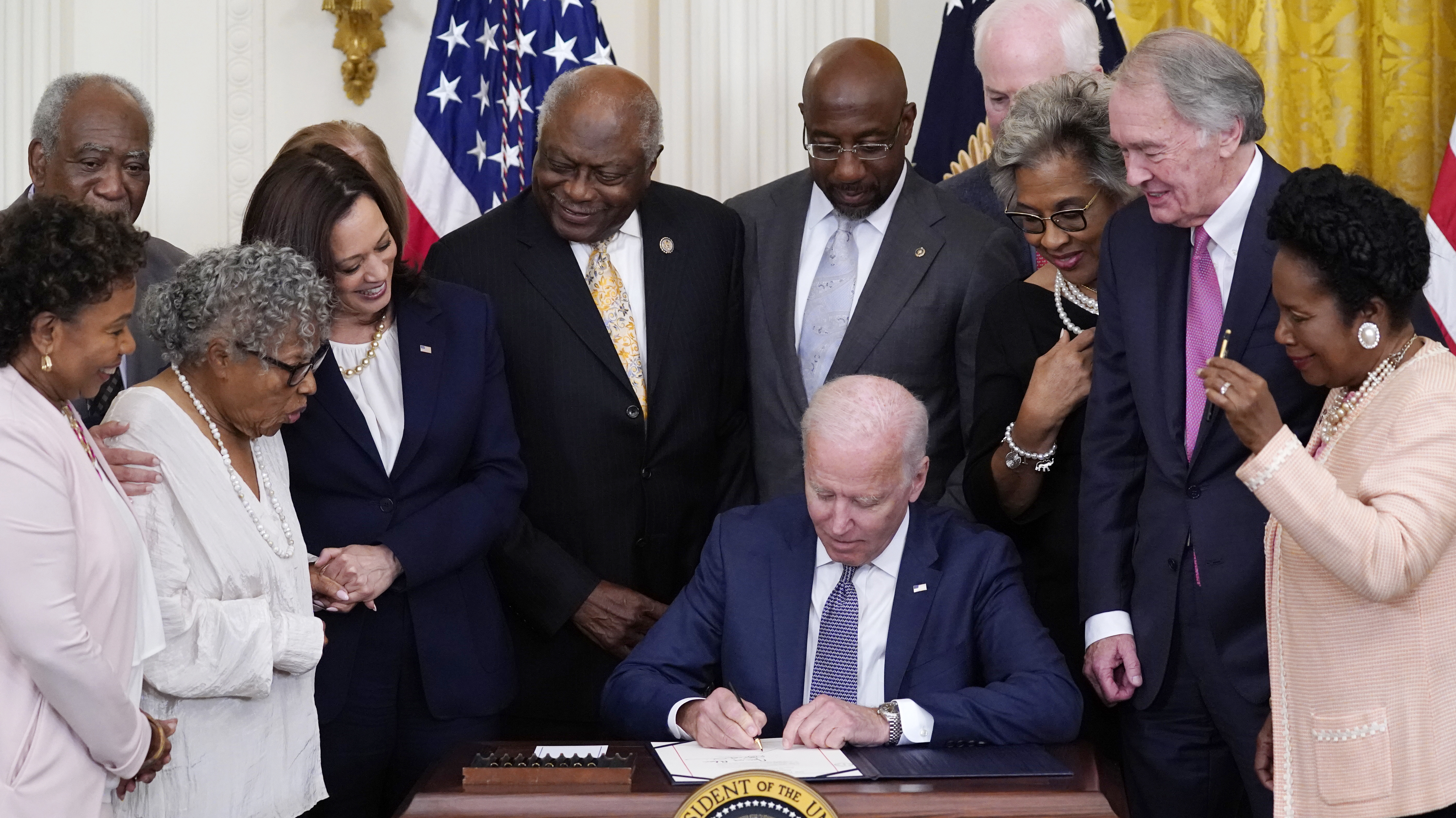 President Biden signs the Juneteenth National Independence Day Act in the East Room of the White House on Thursday.