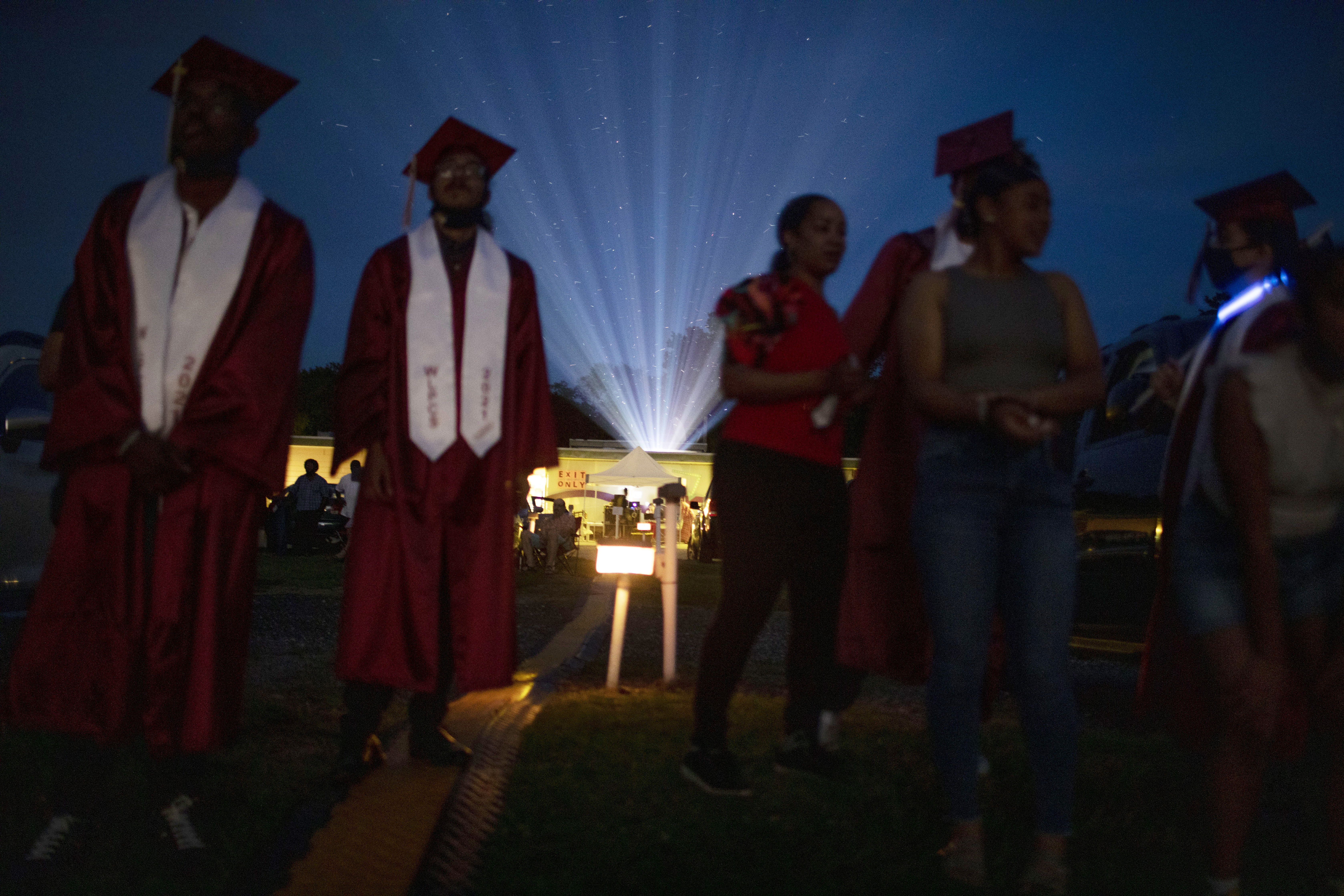 High School Graduations Brought Joy This Year, Even If They Weren't Back To Normal 12 The projector light beams over the crowd at Bengies Drive-In Theatre as Washington Latin's graduation ceremony gets underway.