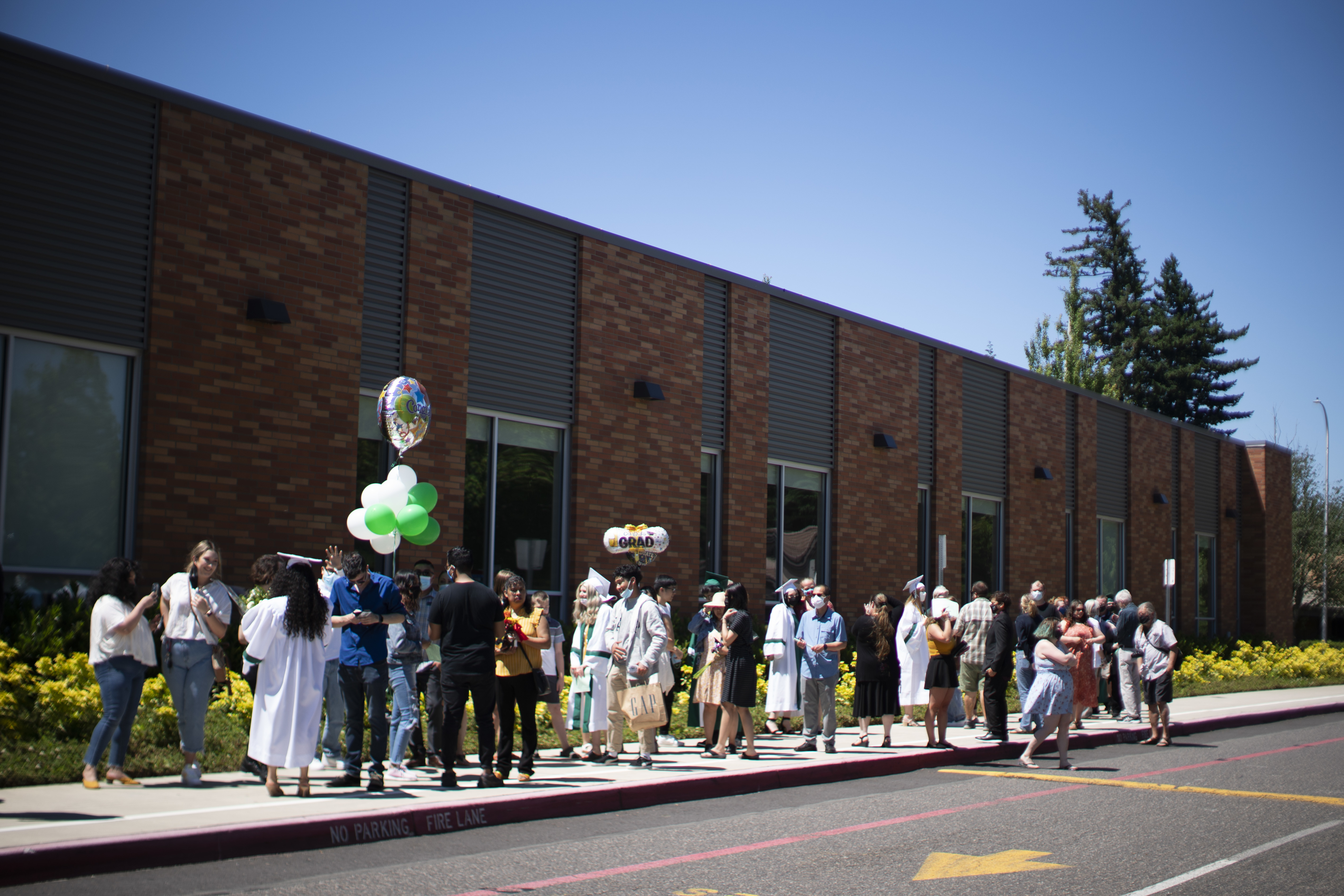 High School Graduations Brought Joy This Year, Even If They Weren't Back To Normal 4 Reynolds High School students wait with their families for their turn to graduate. The school hosted about 600 individual ceremonies to allow for social distancing.