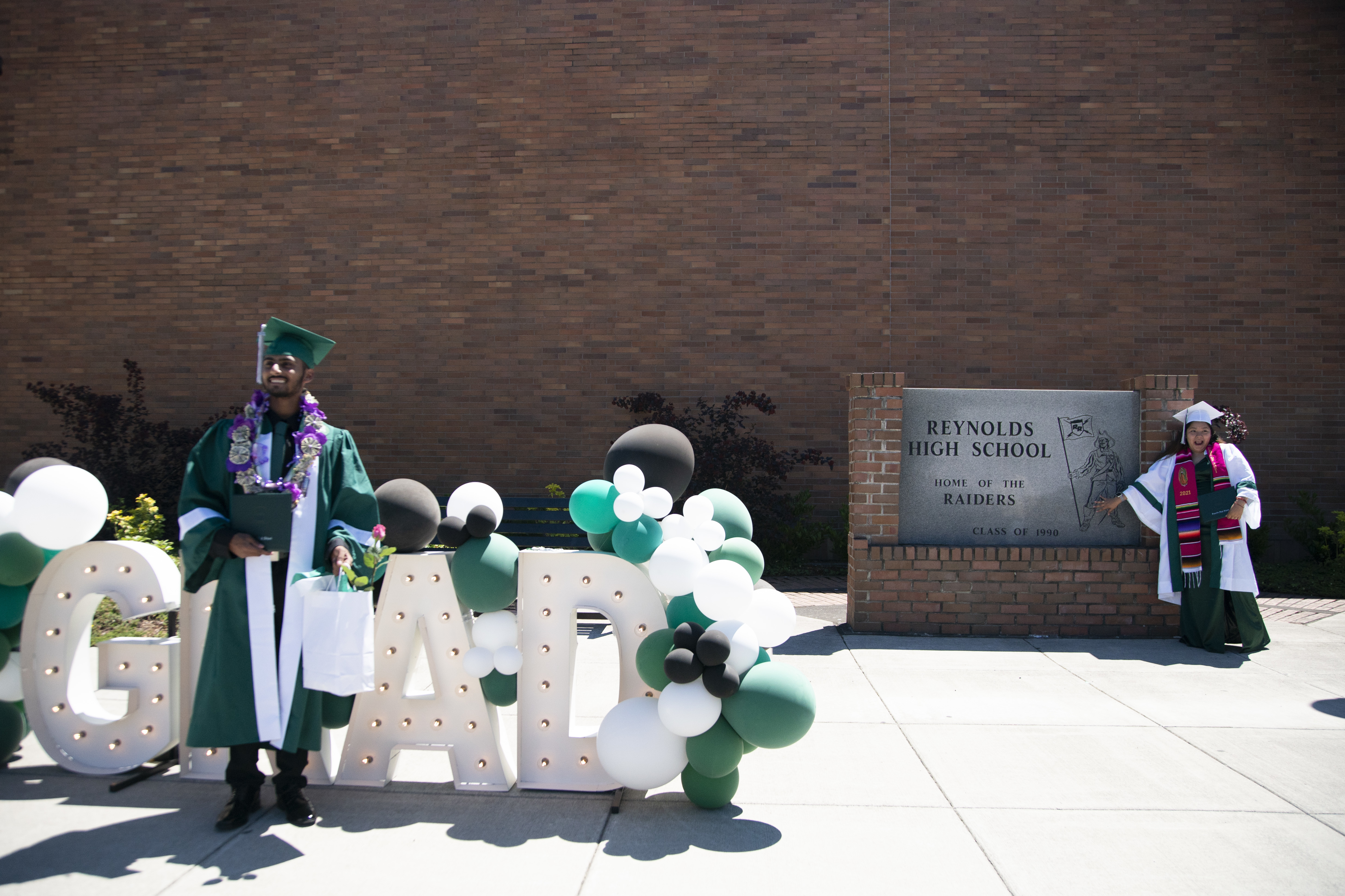 High School Graduations Brought Joy This Year, Even If They Weren't Back To Normal 5 Students pose for pictures on graduation day at Reynolds High School in Troutdale, Ore.