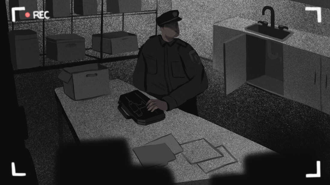 A man is seen through a surveillance camera, moving a toolkit containing a drill.