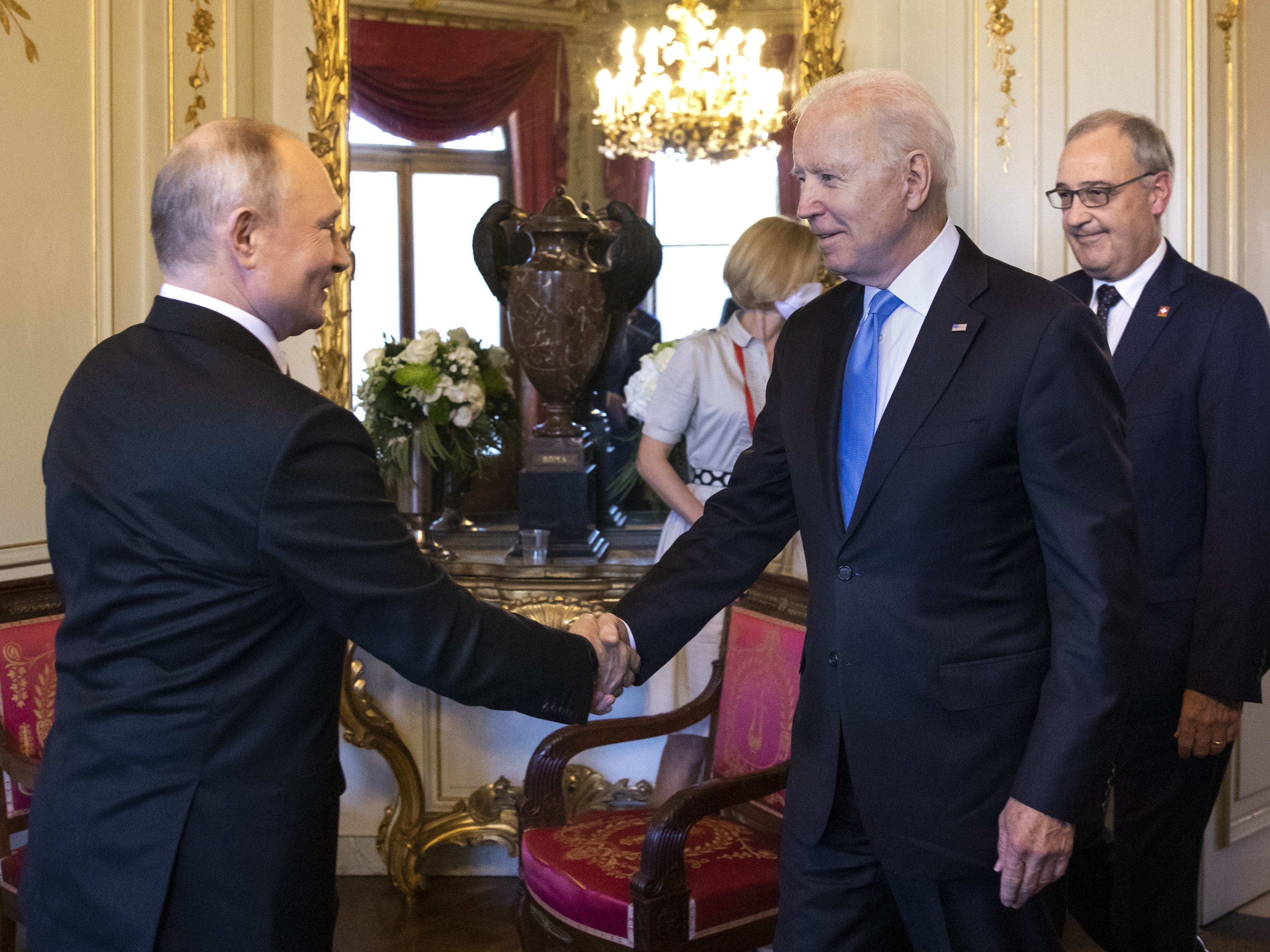 U.S. President Biden and Russian President Vladimir Putin shake hands as Swiss President Guy Parmelin (right) looks on during the U.S.-Russia summit at Villa La Grange on June 16 in Geneva, Switzerland. (Getty Images)