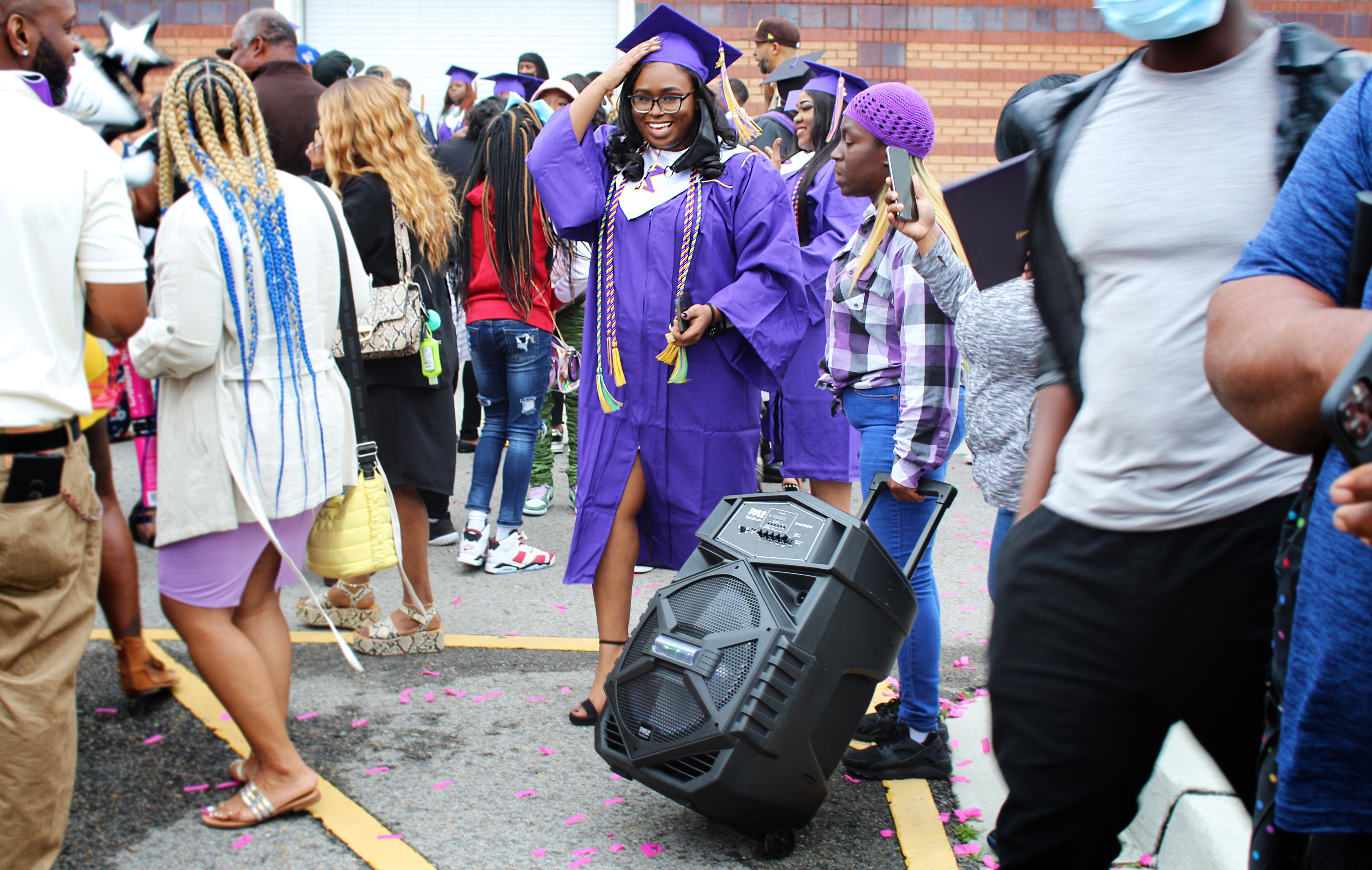 High School Graduations Brought Joy This Year, Even If They Weren't Back To Normal 7 Edna Karr graduate Taylor Morris celebrates outside the Pontchartrain Convention & Civic Center. Morris' aunt, Holly Barnett, brought a rolling boombox that transformed the parking lot into a dance party and second line parade.