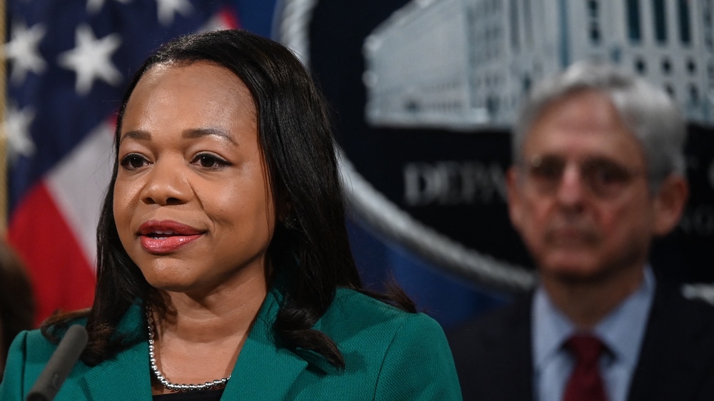 Assistant Attorney General Kristen Clarke for the Justice Department's Civil Rights Division speaks during a news conference Friday announcing a lawsuit against the state of Georgia for its new voting law. Attorney General Merrick Garland is at right. (AFP via Getty Images)