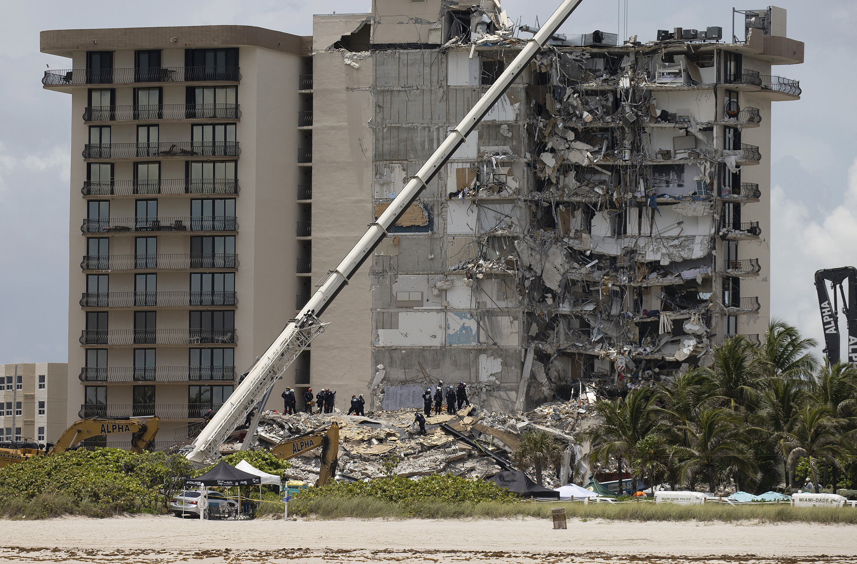 Members of the South Florida Urban Search and Rescue Team look for survivors in the partially collapsed 12-story Champlain Towers South condo building in Surfside, Fla. (Getty Images)