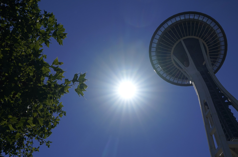 The sun shines near the Space Needle, Monday, June 28, 2021, in Seattle. Seattle and other cities broke all-time heat records over the weekend, with temperatures soaring well above 100 degrees. (Ted S. Warren/AP)