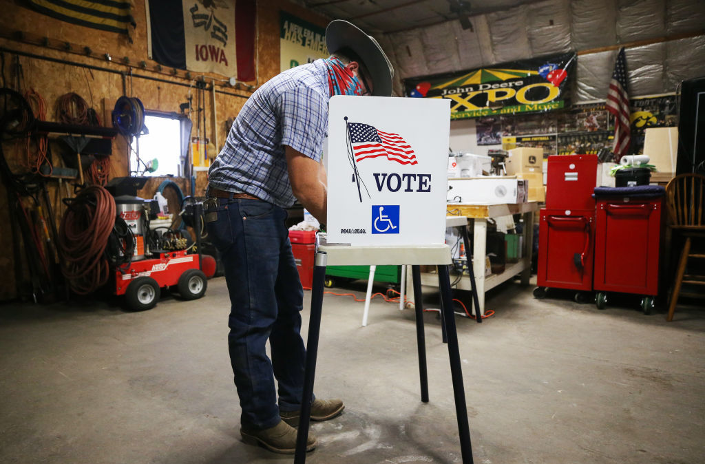 A voter marks his ballot at a polling place on Nov. 3 in Richland, Iowa. A new poll finds ensuring access to voting is more important than tamping down on voter fraud for most Americans. (Getty Images)