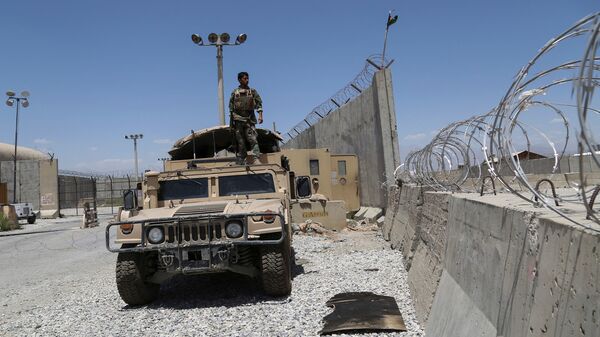 An Afghan National Army soldier looks out while standing on a Humvee vehicle at Bagram Air Base, on July 2, after all U.S. and NATO troops left.