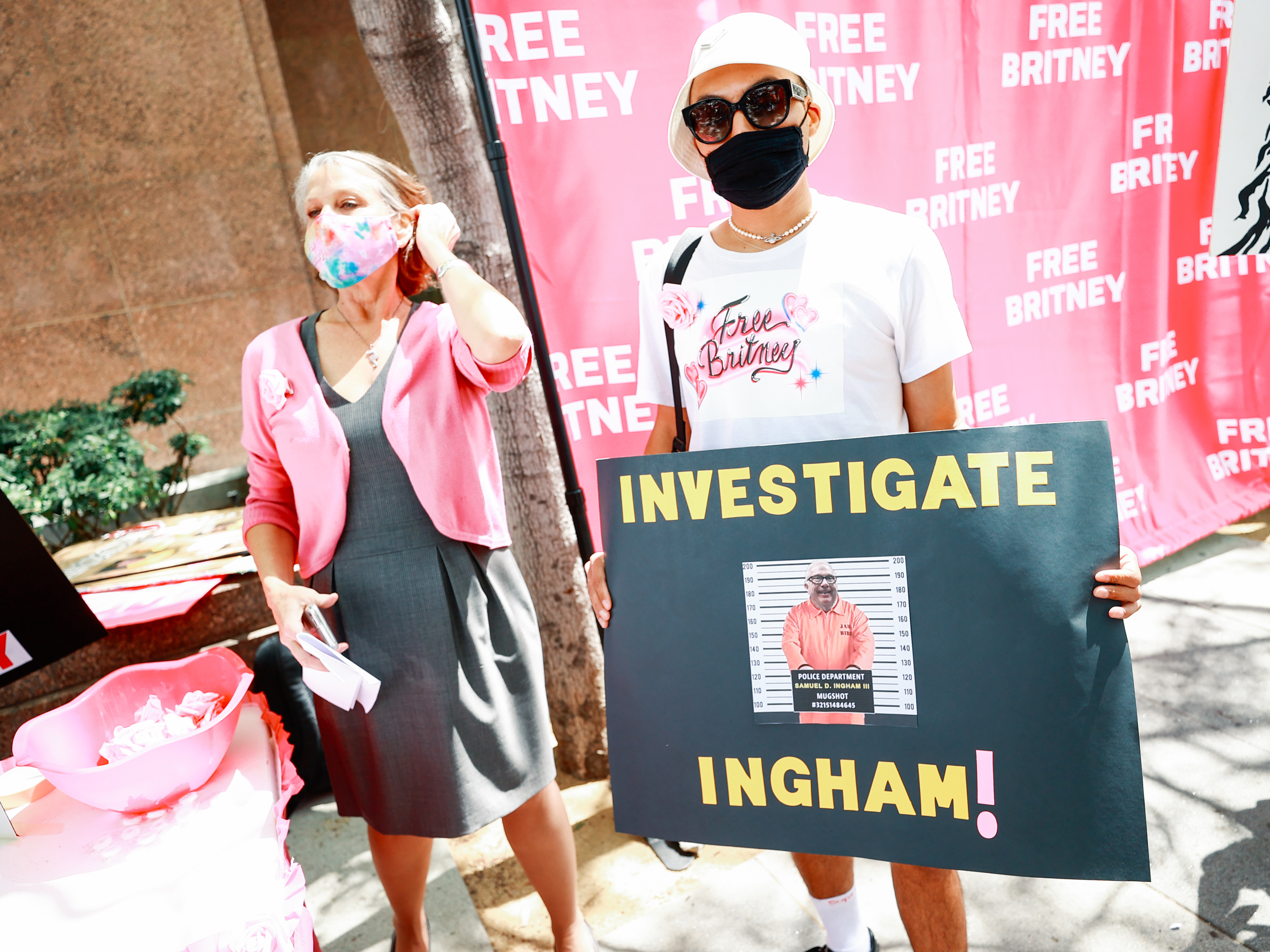 #FreeBritney activists protesting outside a Los Angeles courthouse, sporting a sign that reads &quot;Investigate Ingham!&quot; (Getty Images)