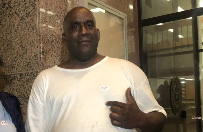 Hervis Rogers points to his &quot;I voted&quot; sticker on Super Tuesday in 2020. This week he was arrested for allegedly voting while on parole, which is illegal in Texas. (Houston Public Media)