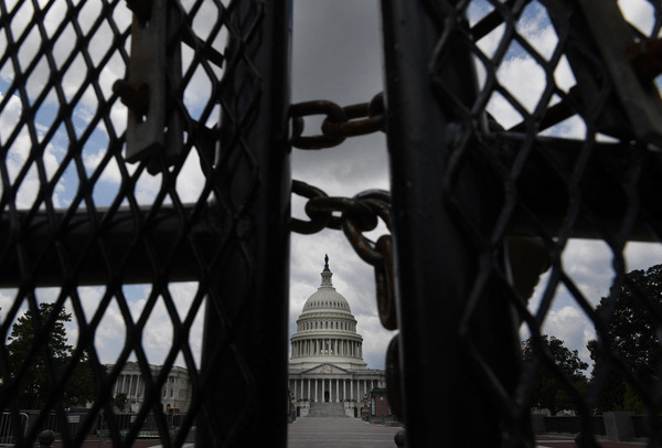 The U.S. Capitol is seen behind fences on July 9, the day crews began to take the temporary structure down.