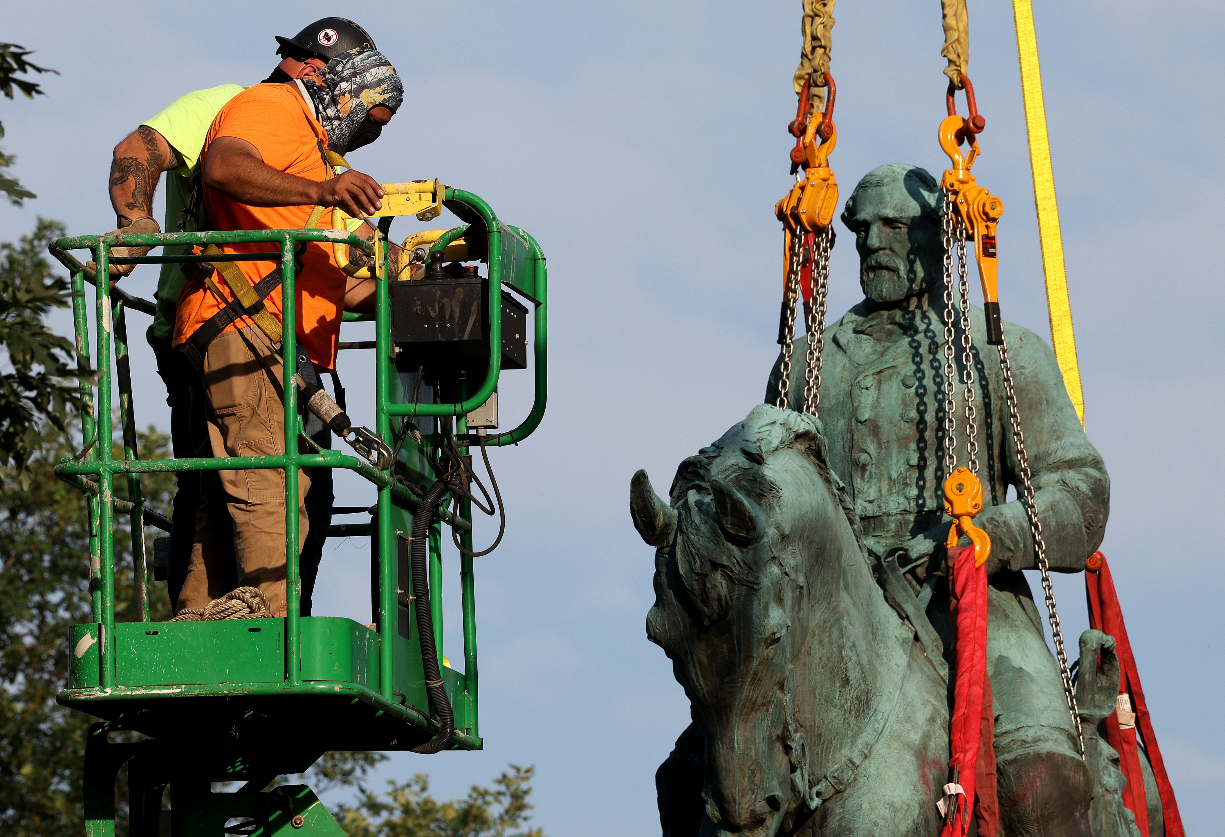 Workers remove a statue of Confederate Gen. Robert E. Lee from Market Street Park on Saturday in Charlottesville, Va. (Getty Images)