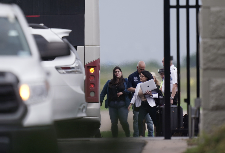 Democrats from the Texas Legislature arrive by bus to board a private plane in Austin to travel to Washington, D.C., on Monday. The lawmakers fled the state to try to block action on GOP election bills. (Eric Gay/AP)